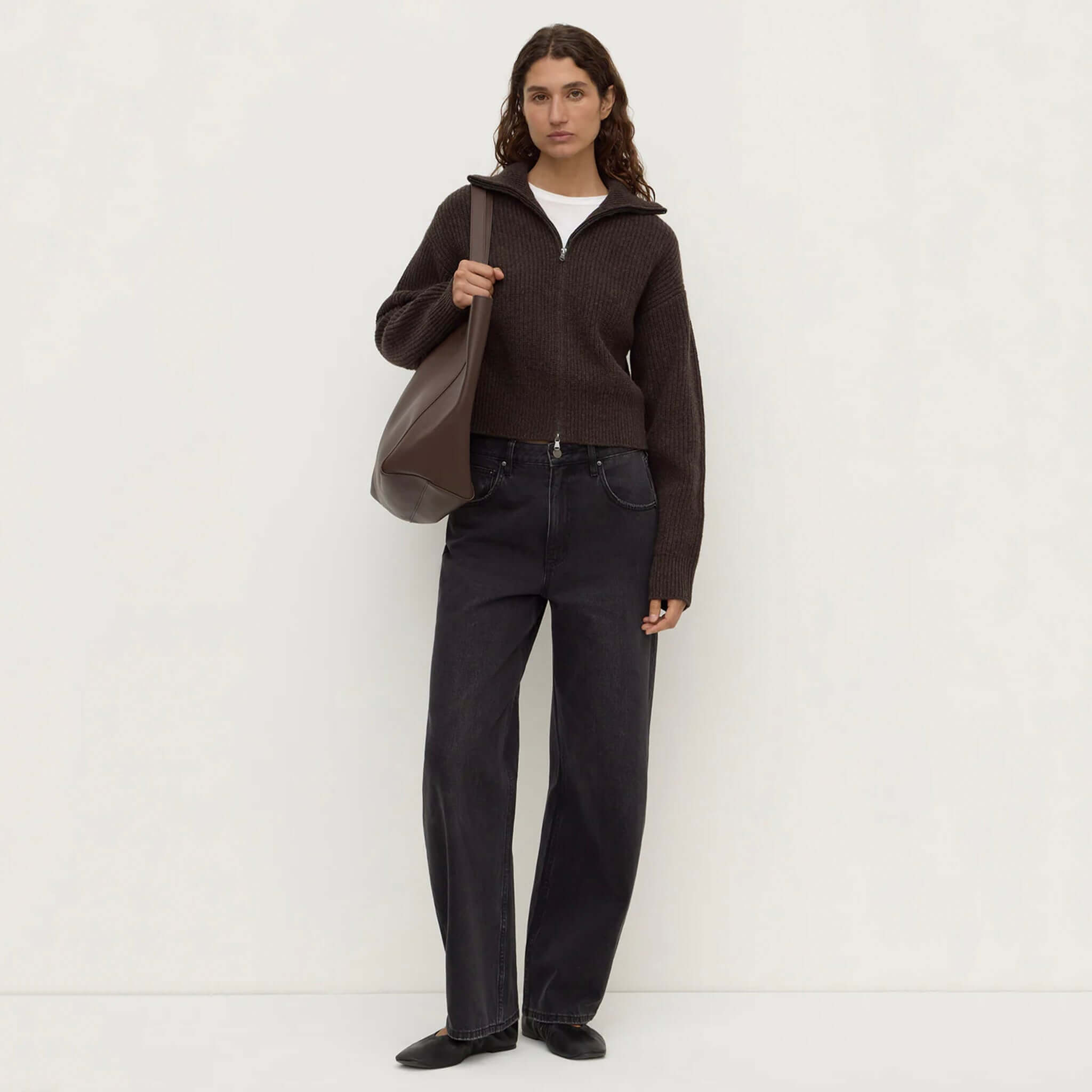 Model wearing Assembly Label Kaia Wool Zip Sweater - Ganache Marle with high-waisted jeans and a bag.