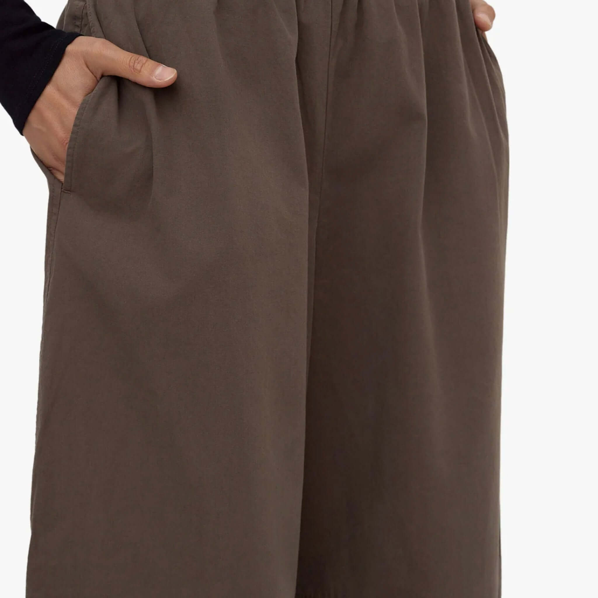Close-up of Assembly Label barrel pants in bark color, showcasing pockets and relaxed fit.