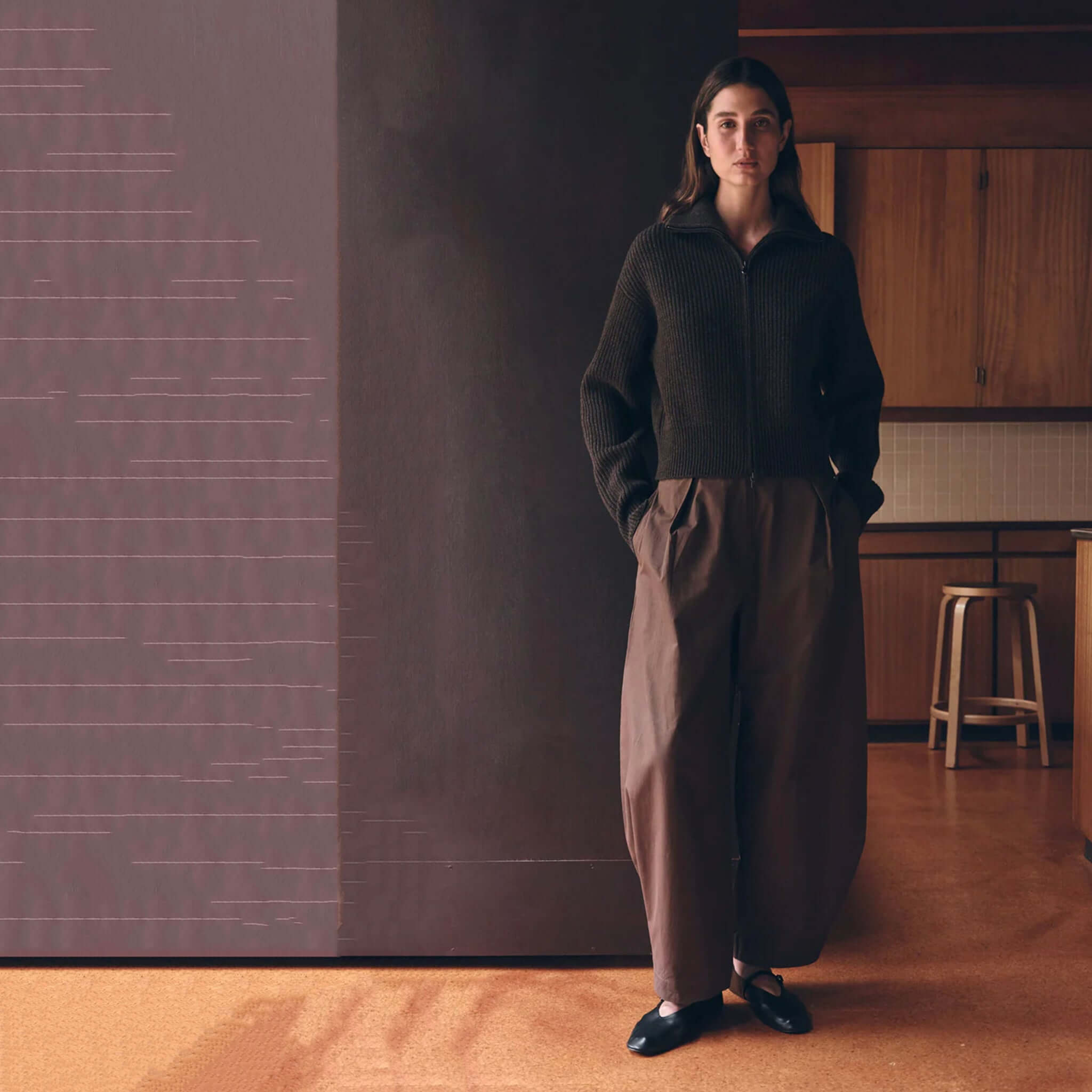 Assembly Label Lola Barrel Pants - Ganache worn with a knitted sweater in a cozy indoor setting.