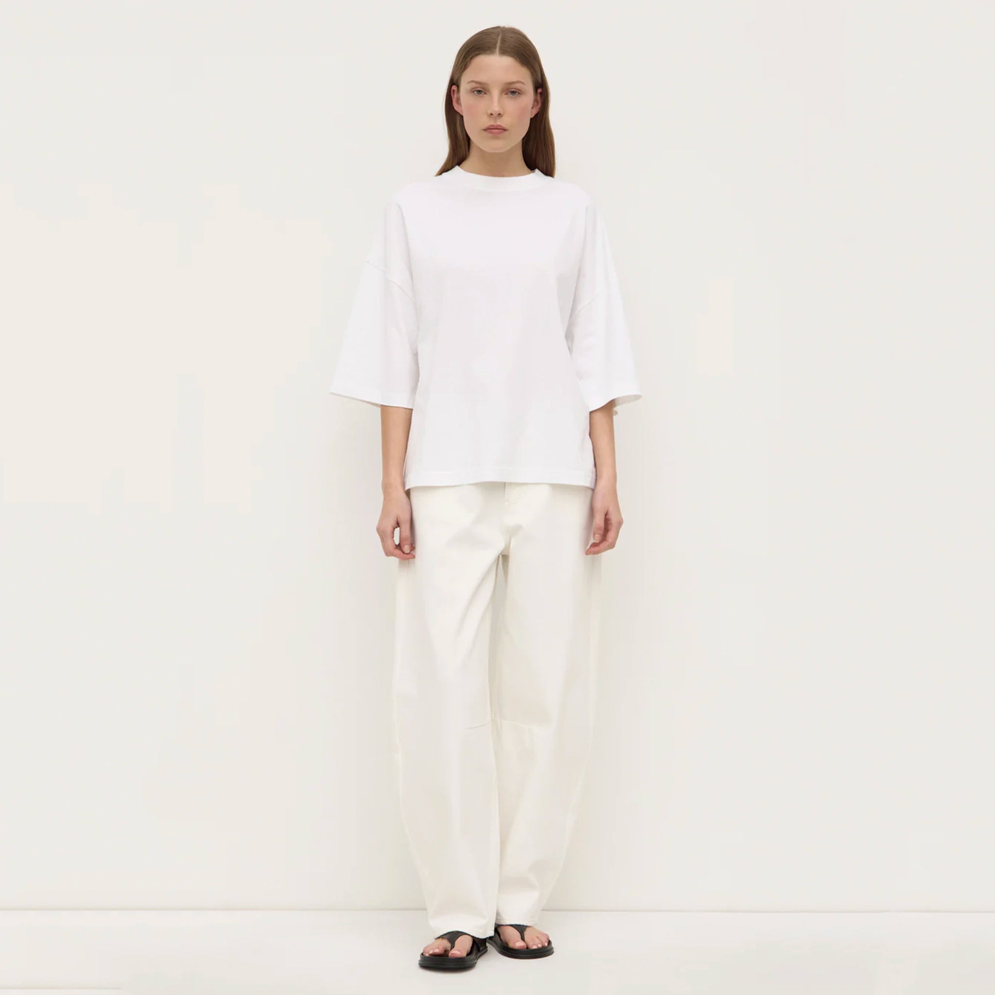 Person wearing a white outfit on a plain background