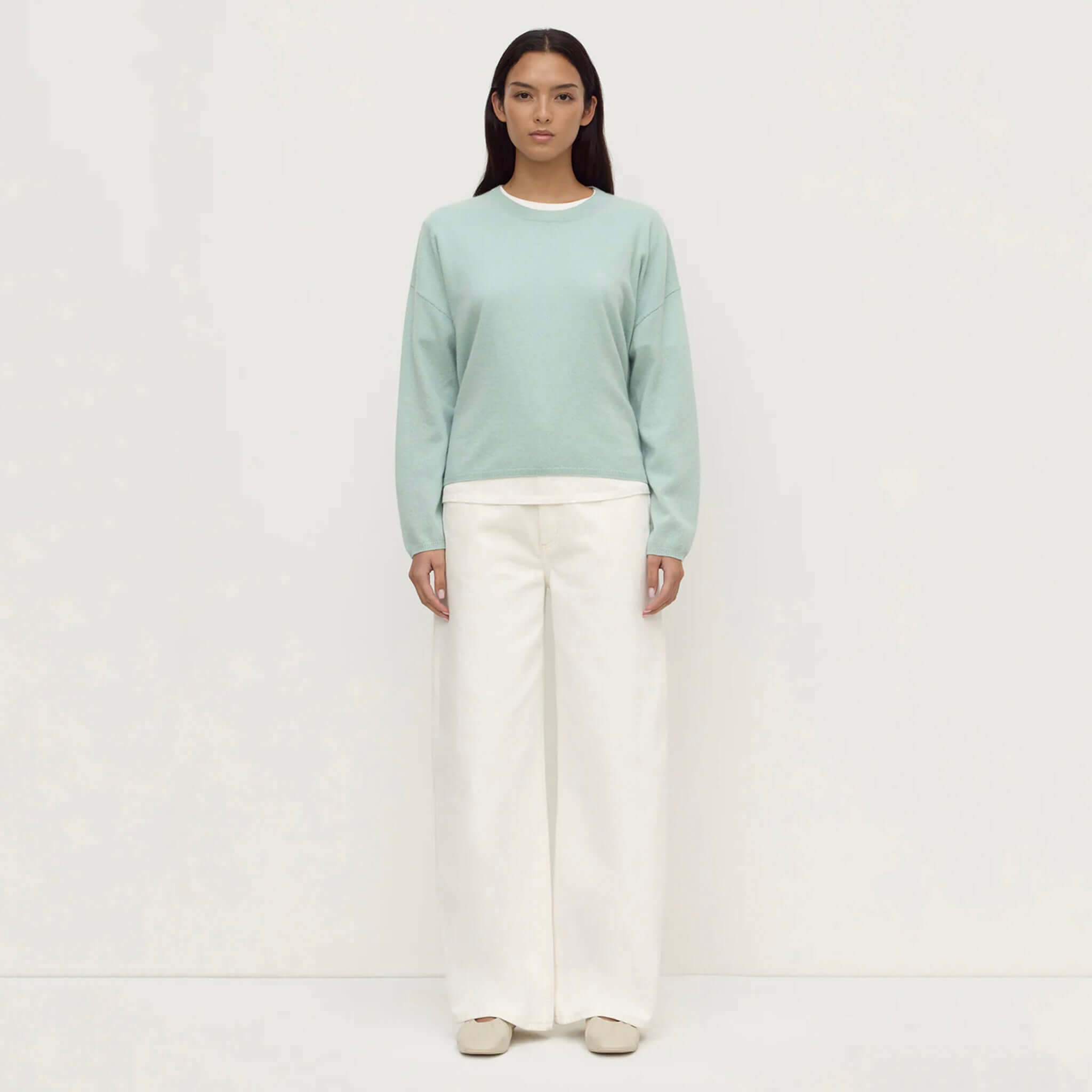 Assembly Label Odelle Cashmere Knit Jumper - Mint worn with wide-leg white pants, showcasing its relaxed silhouette.