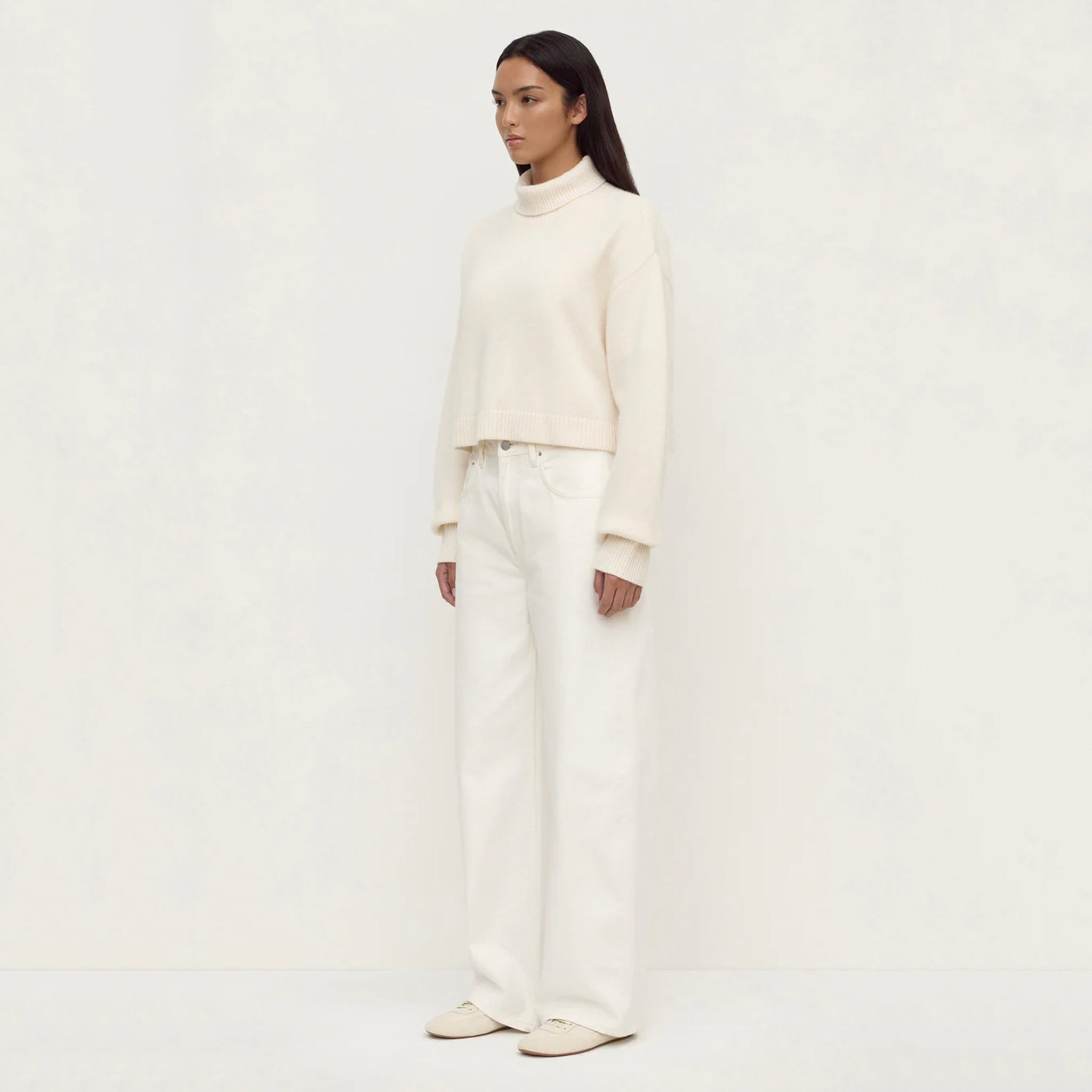 Assembly Label Paris Wool & Cashmere Knit Turtleneck - White worn with wide-leg white jeans, showcasing a relaxed style.