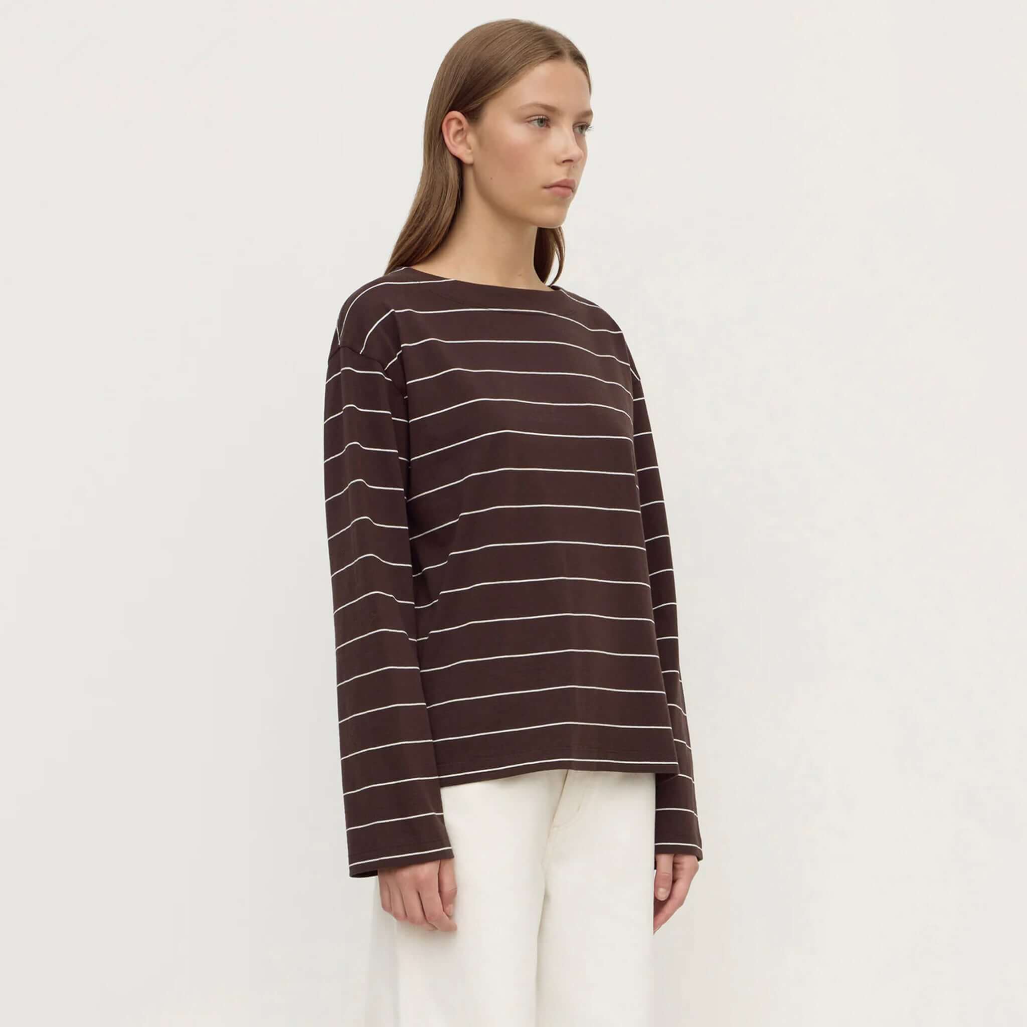 Assembly Label Scout Long Sleeve Tee - Ganache Cream Stripe worn by a model, featuring wide boat neckline and flared sleeves.