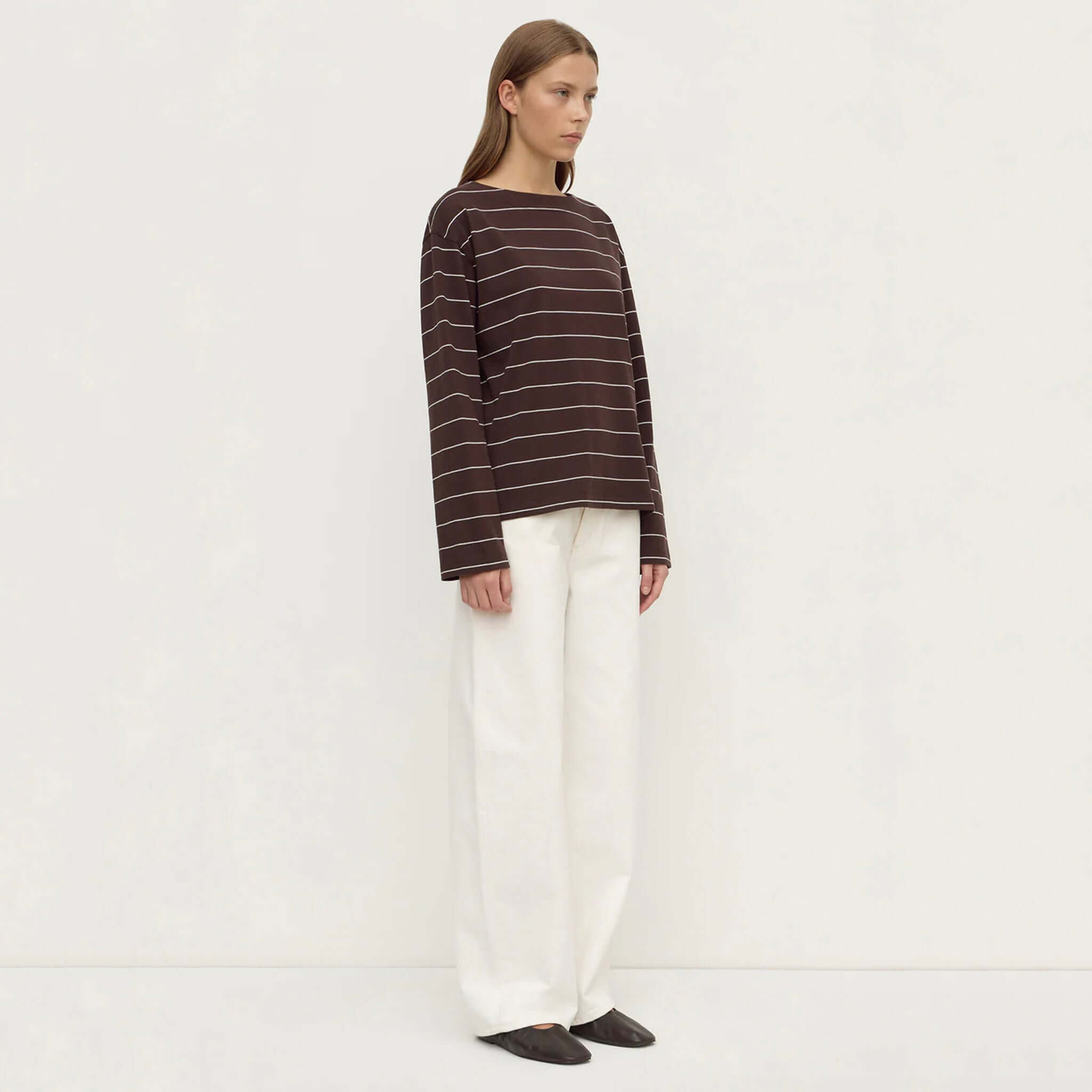 Assembly Label Scout Long Sleeve Tee - Ganache Cream Stripe worn with white pants, showcasing relaxed fit and wide neckline.