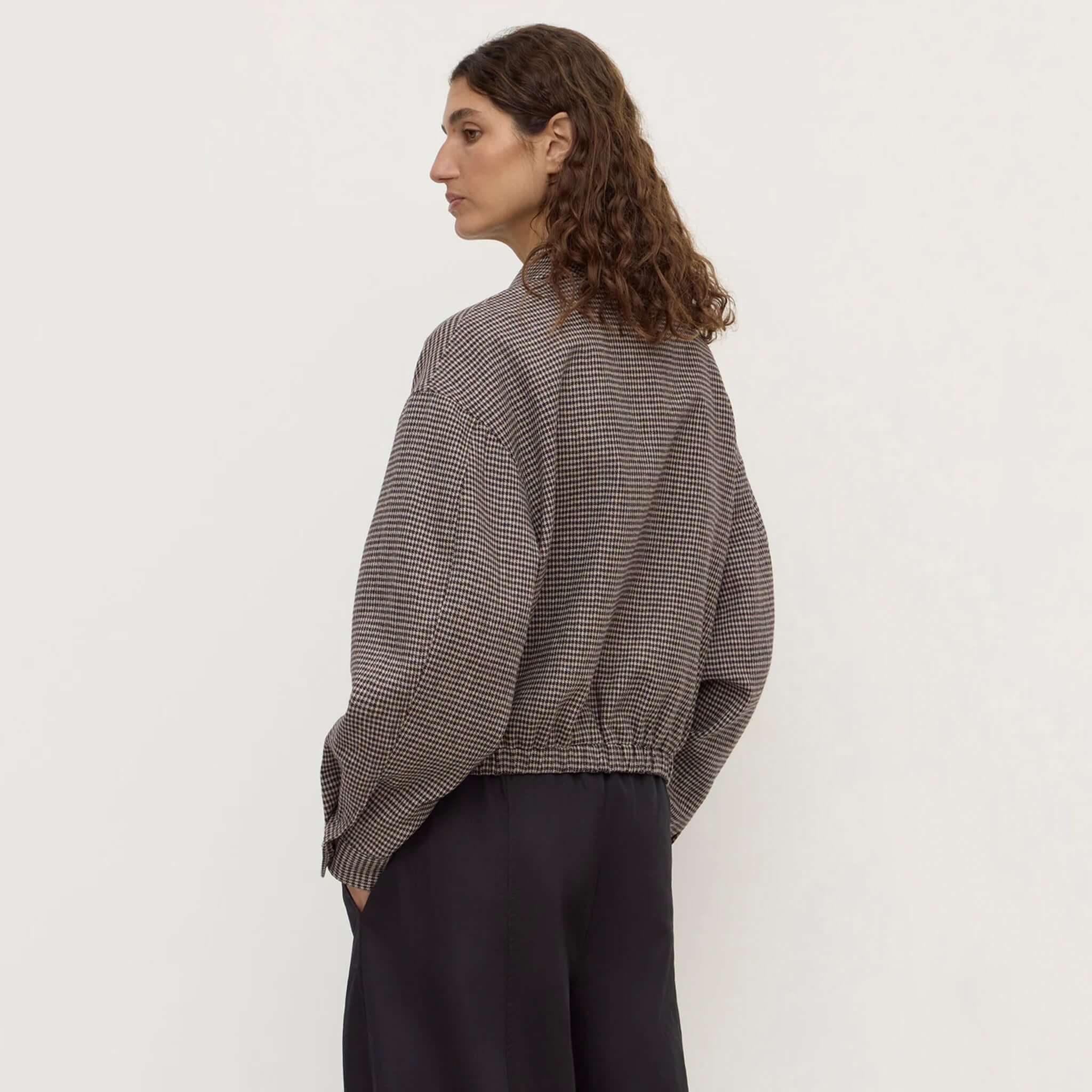 Assembly Label Solana Wool Jacket - Brown Black Check worn by a model showcasing its cropped design and gathered elastic hem.