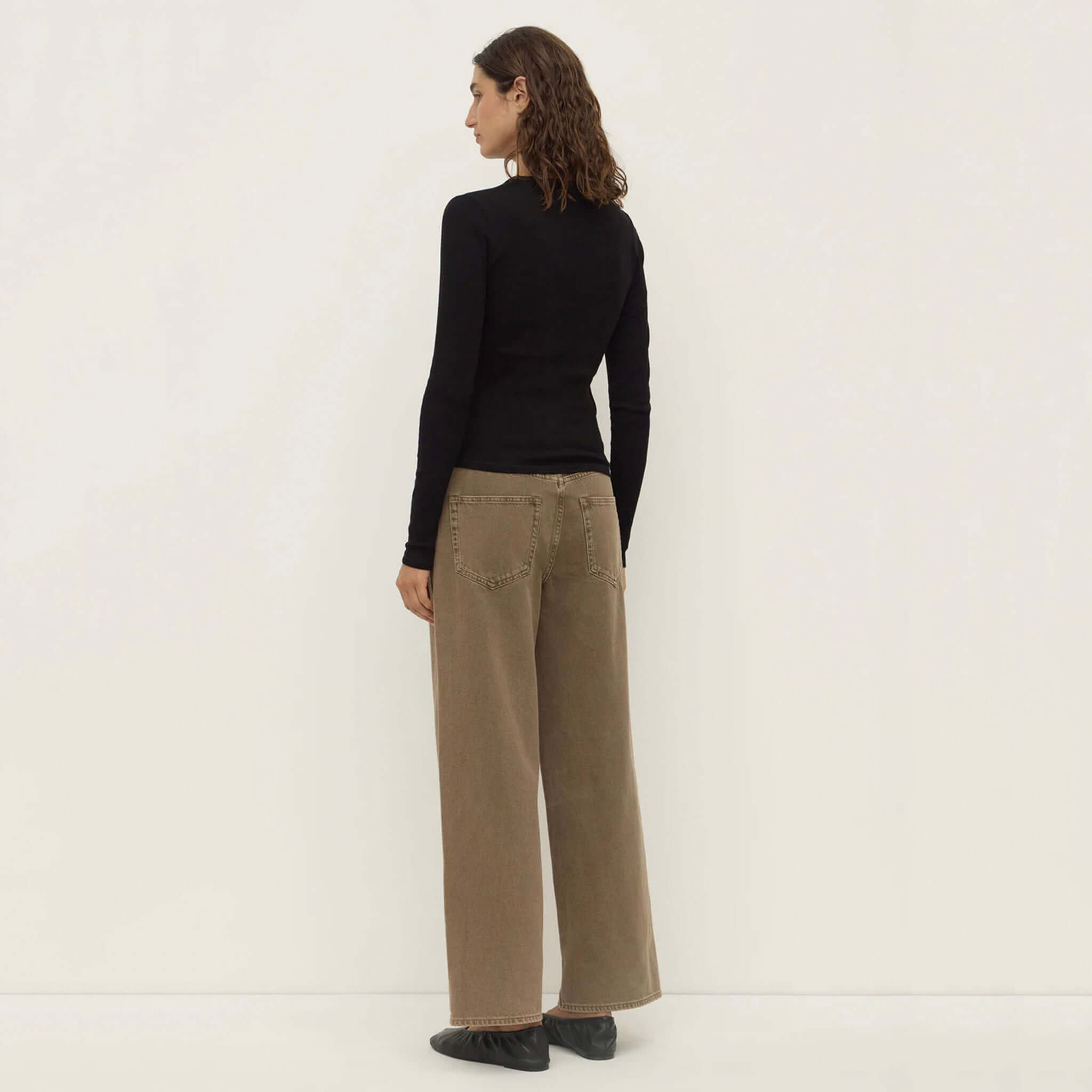 Alt Tag: Assembly Label Zali Long Sleeve Tee - Black ribbed fitted long sleeve cotton tee, back view layered with wide leg pants