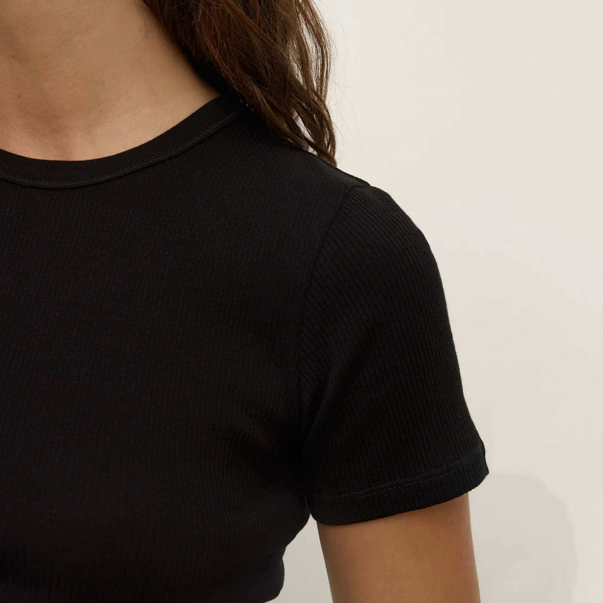 Alt Tag: Assembly Label Zali Short Sleeve Tee - Black ribbed fitted cotton crew neck tee, close-up of short sleeve and neckline