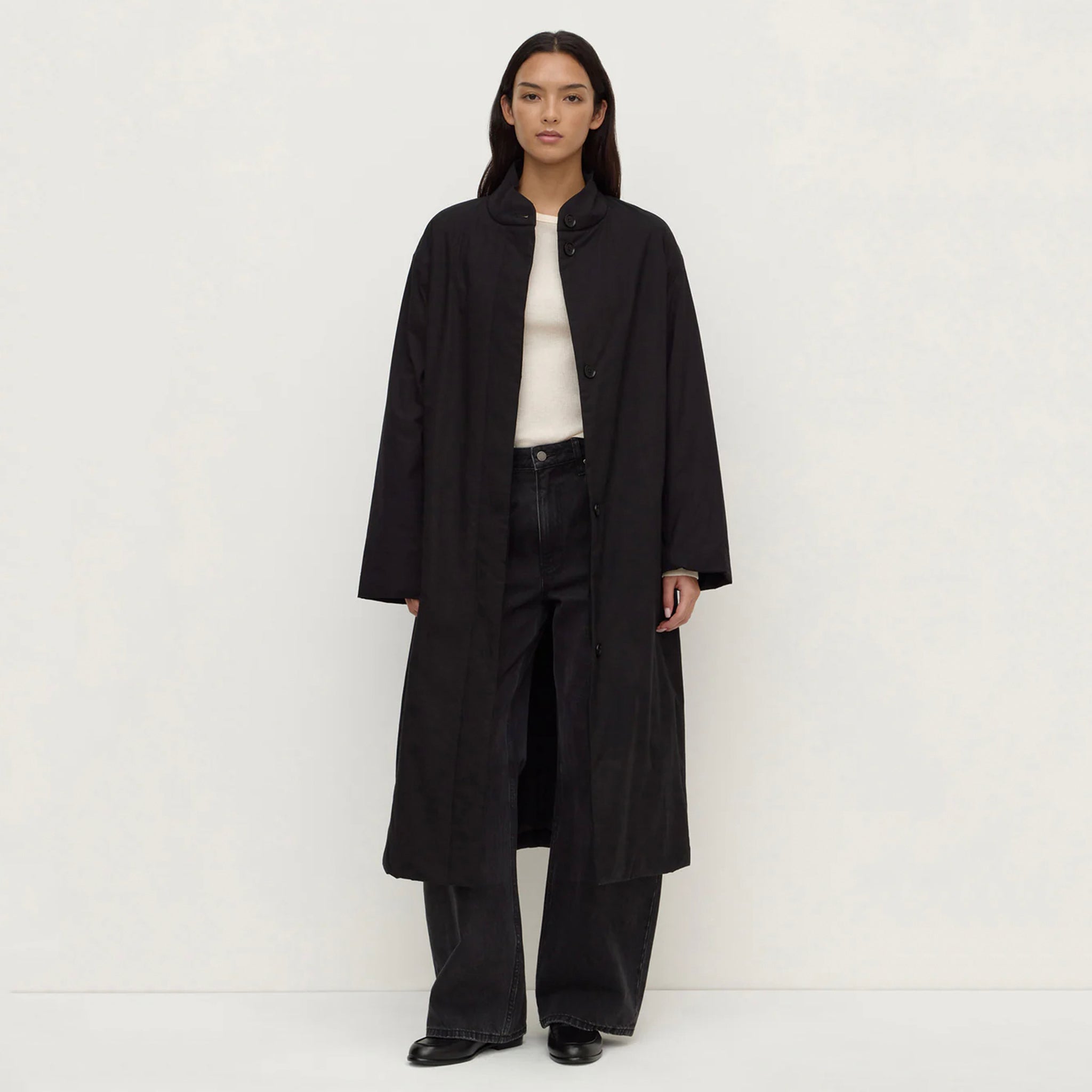 Model wearing Assembly Label Zoie Padded Coat - Black, a modern and timeless coat, showcasing its sleek design.