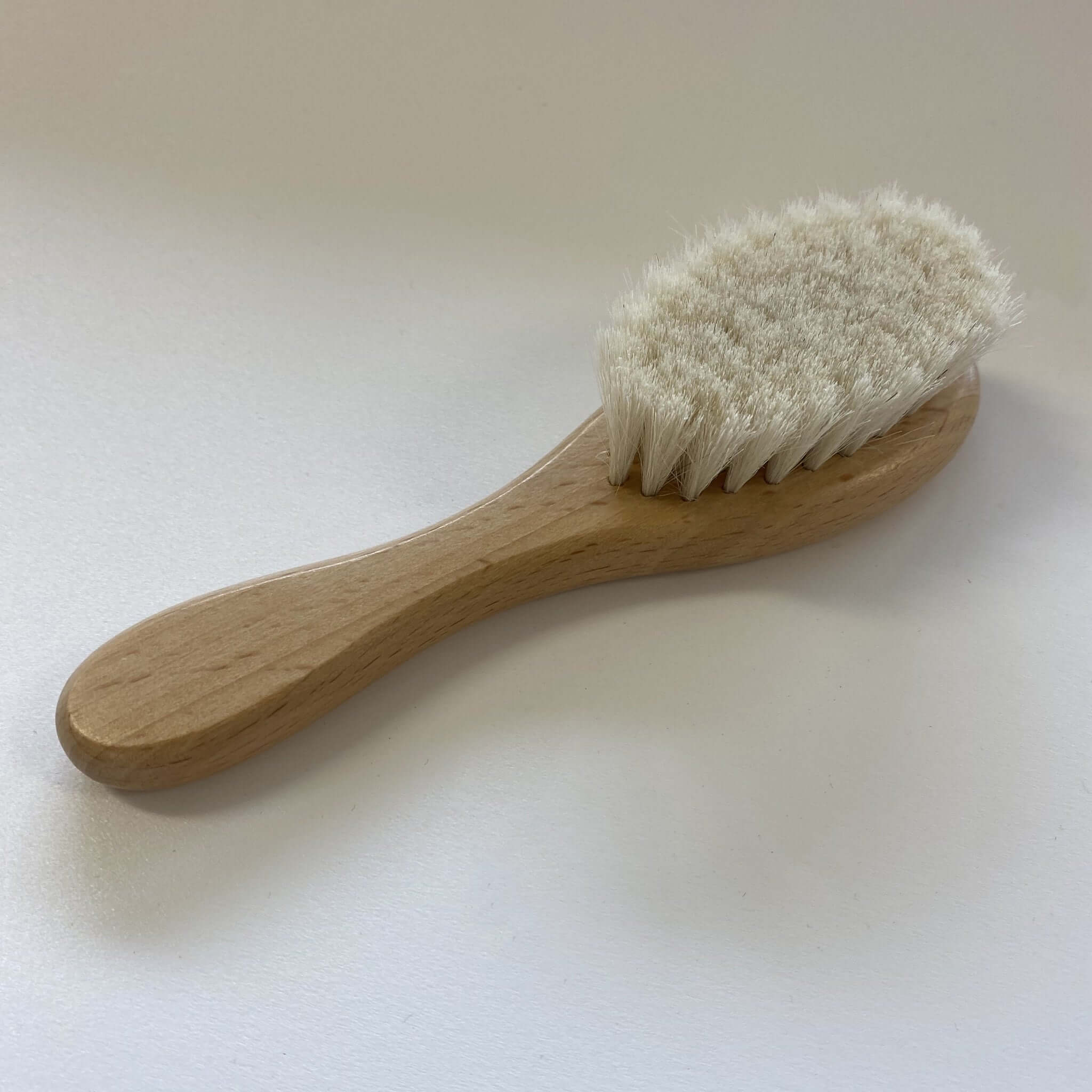 Baby Soft Hair Brush made from wood with ultra-soft goat-hair bristles for delicate newborn scalps.
