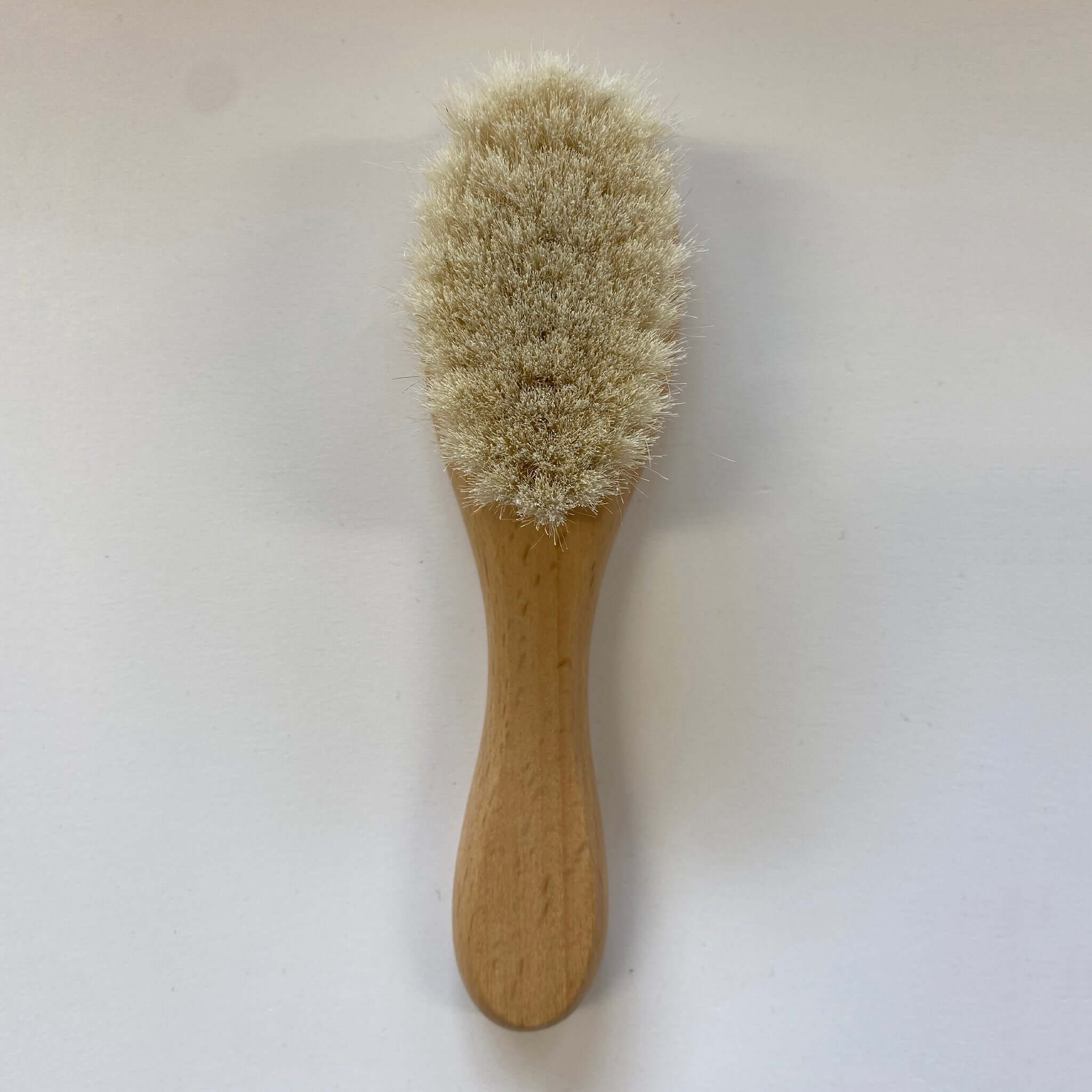 Baby Soft Hair Brush with smooth wooden handle and ultra-soft goat-hair bristles, perfect for delicate newborns.