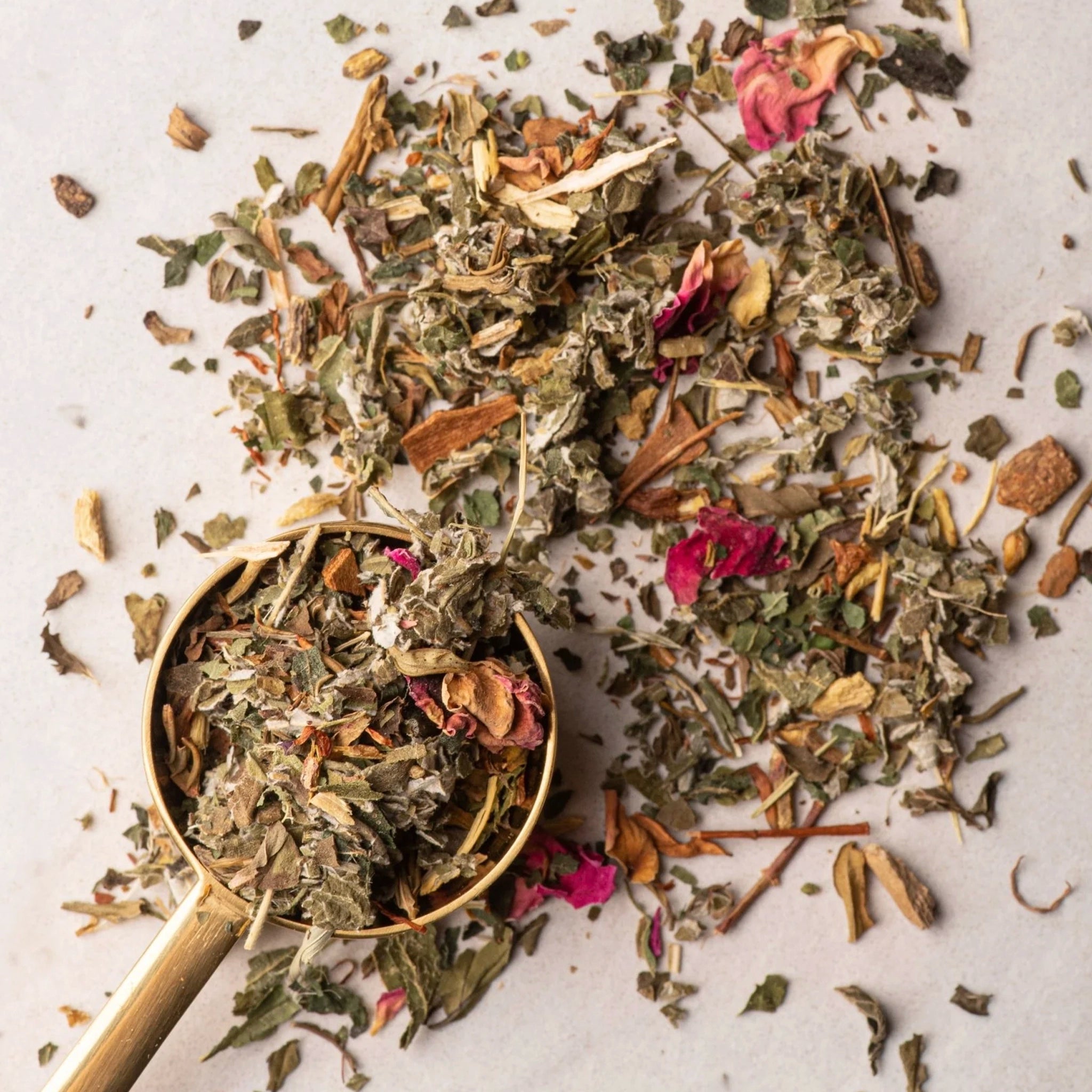 Spice mix with a gold spoon on a light background