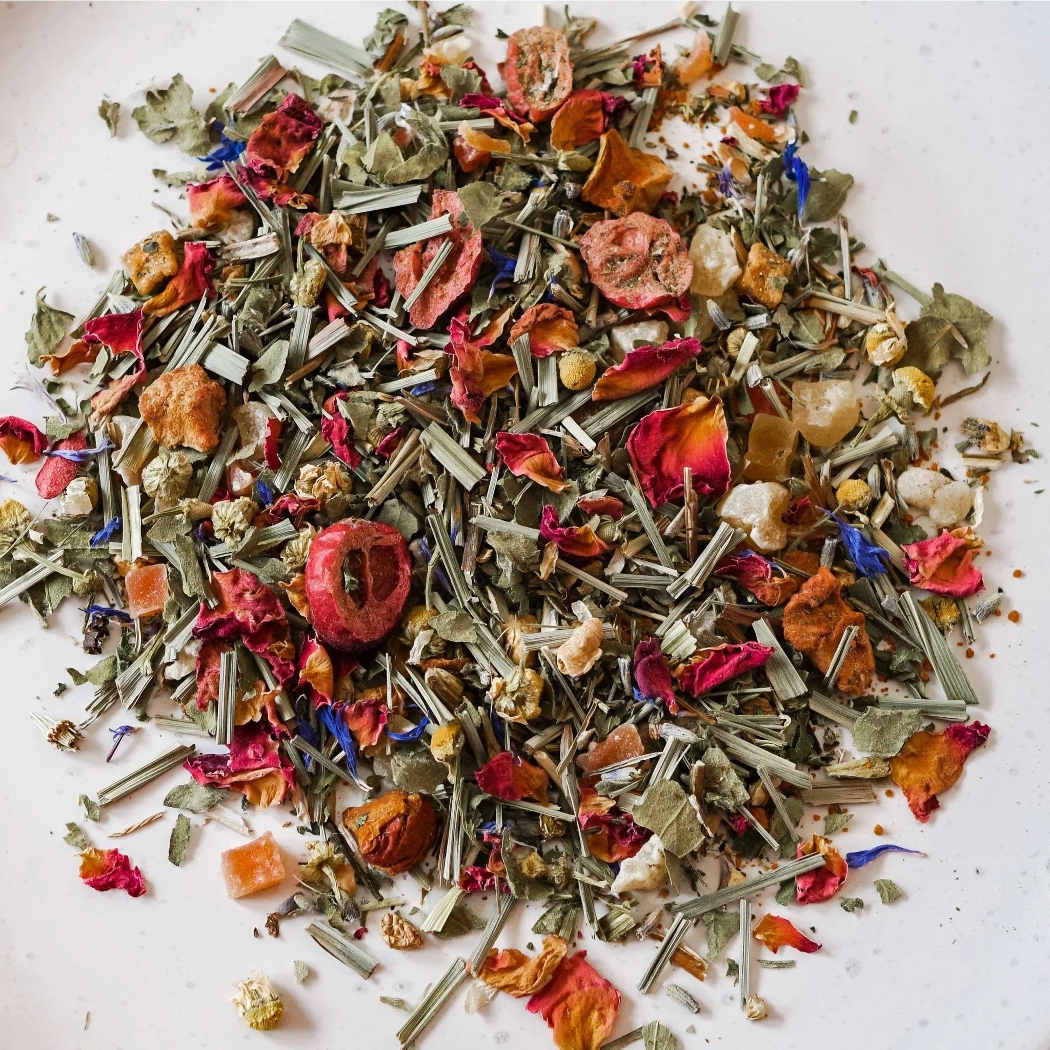 Assorted dried herbs and flowers on a white background