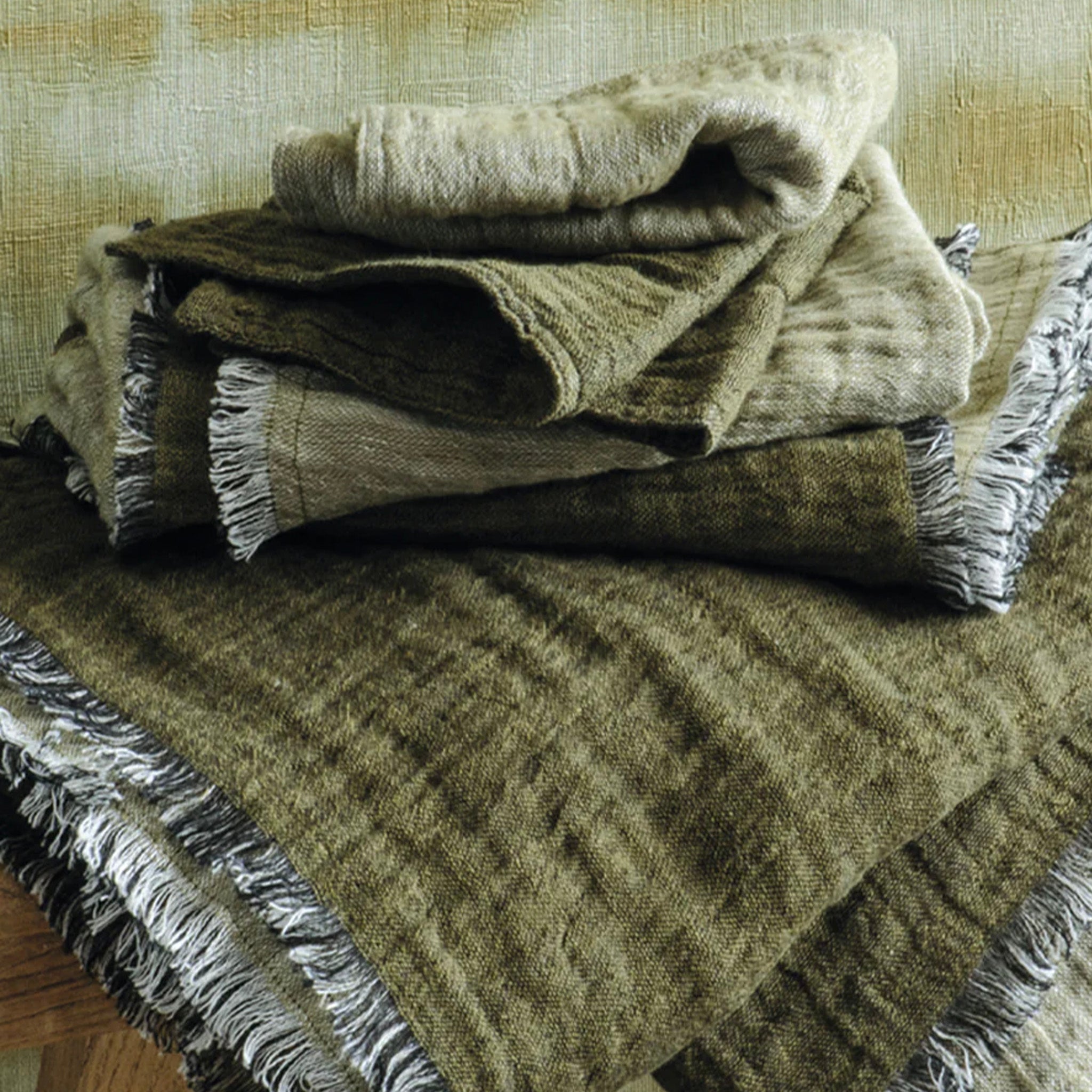 Stack of green plaid wash cloths on a surface