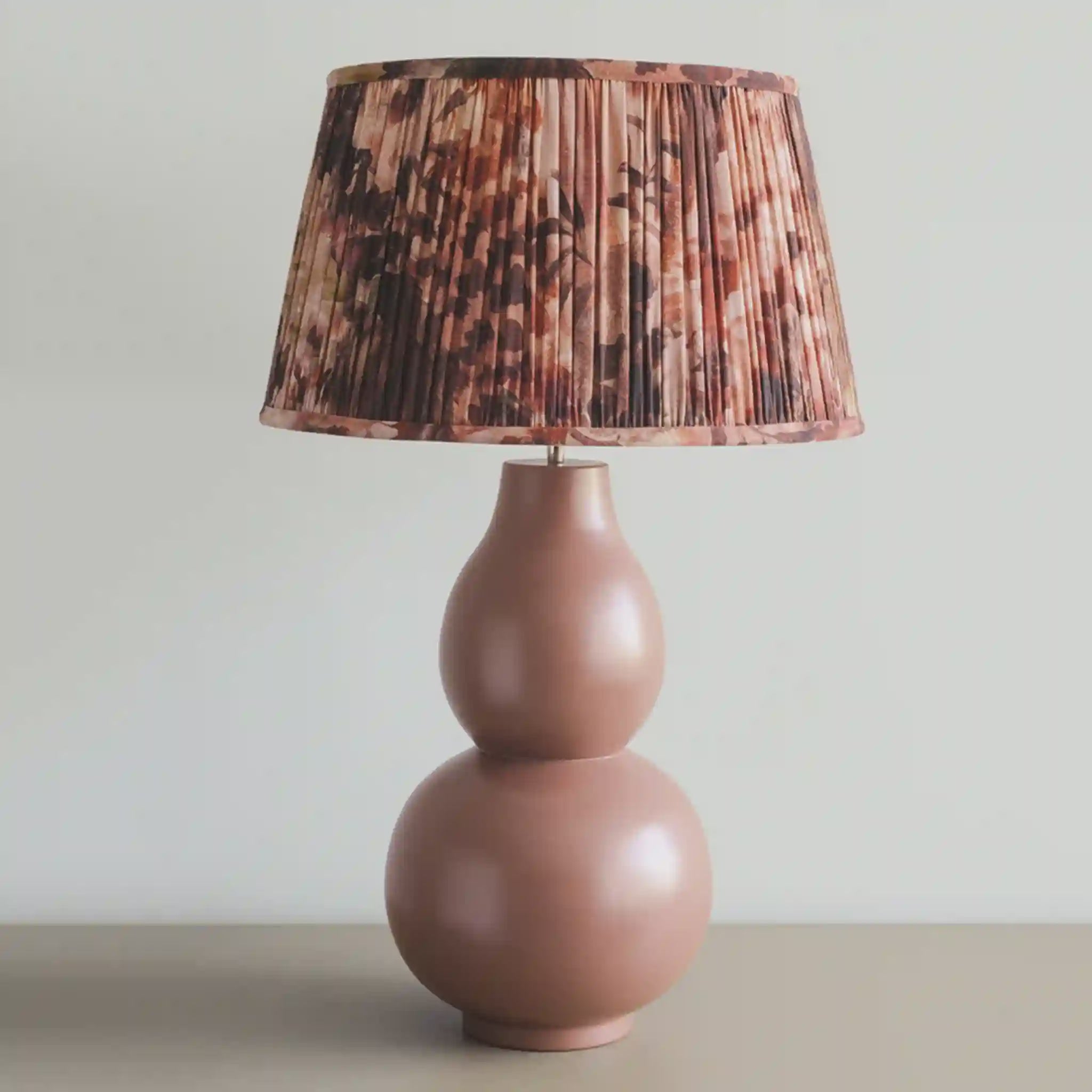 Decorative lamp with a patterned shade on a neutral background
