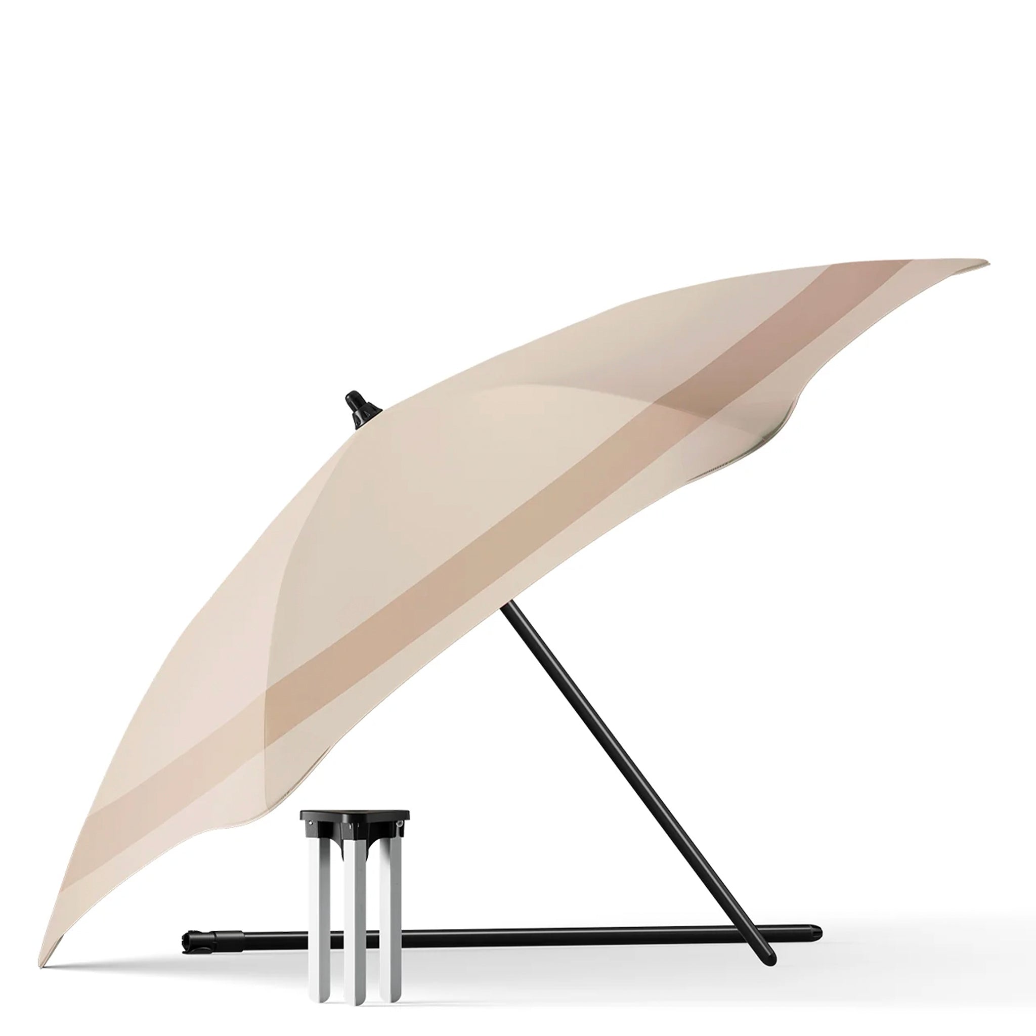 Beige umbrella with black handle and stand on a white background
