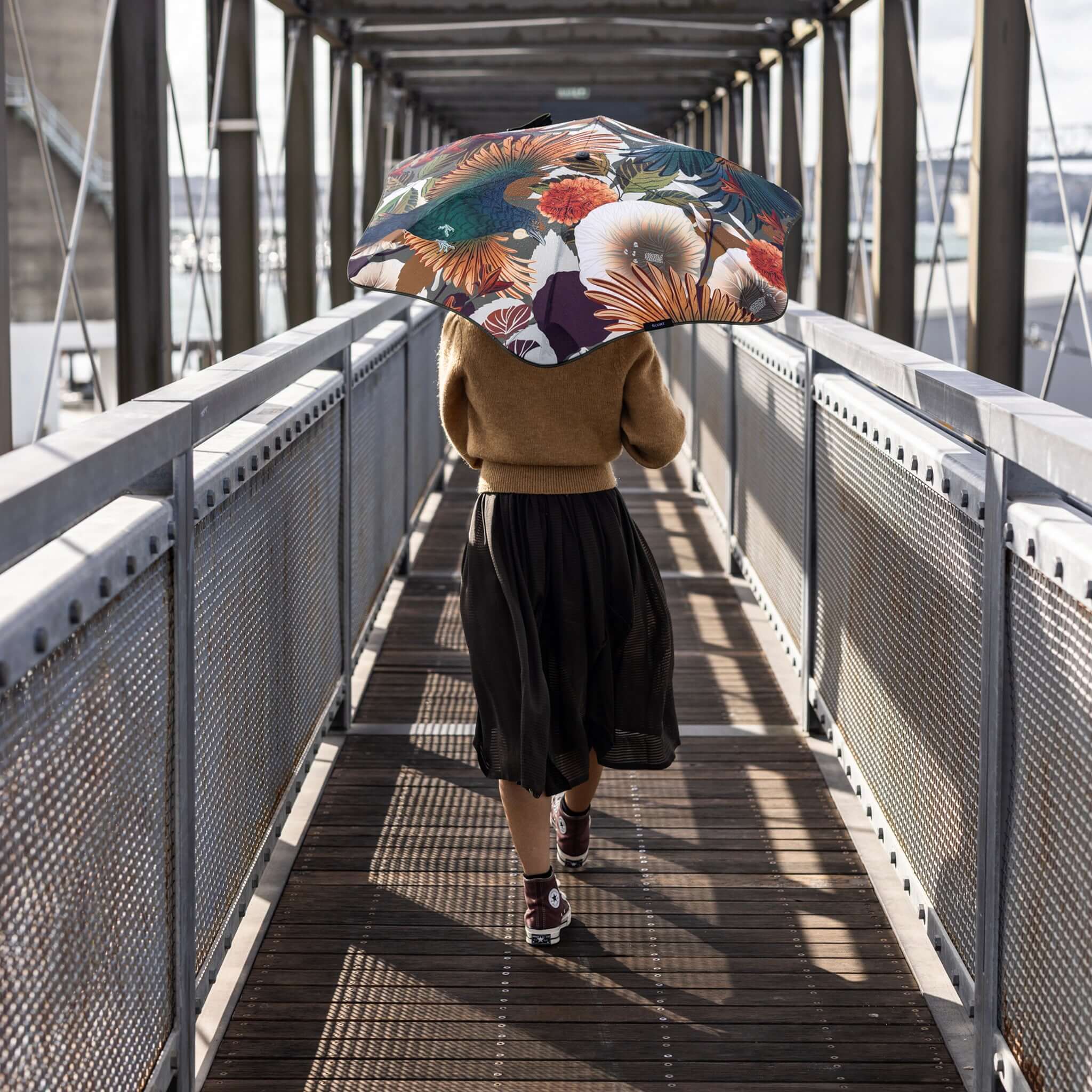 Blunt Metro Umbrella Flox 2026 Limited Edition in vibrant native flora design on a walkway.