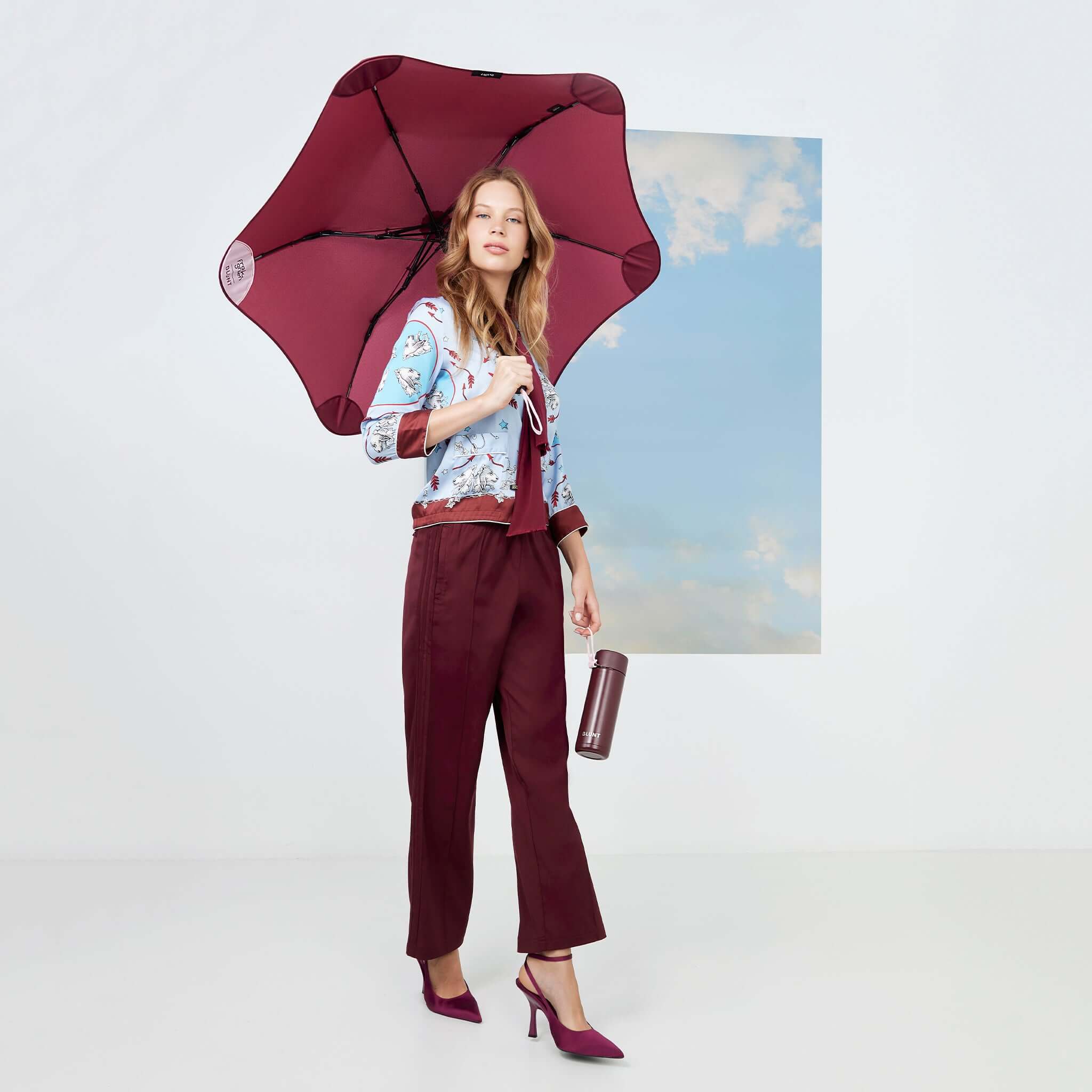Blunt Metro x Frank Green Bundle - Plum & Petal umbrella and accessory modelled in stylish urban outfit.