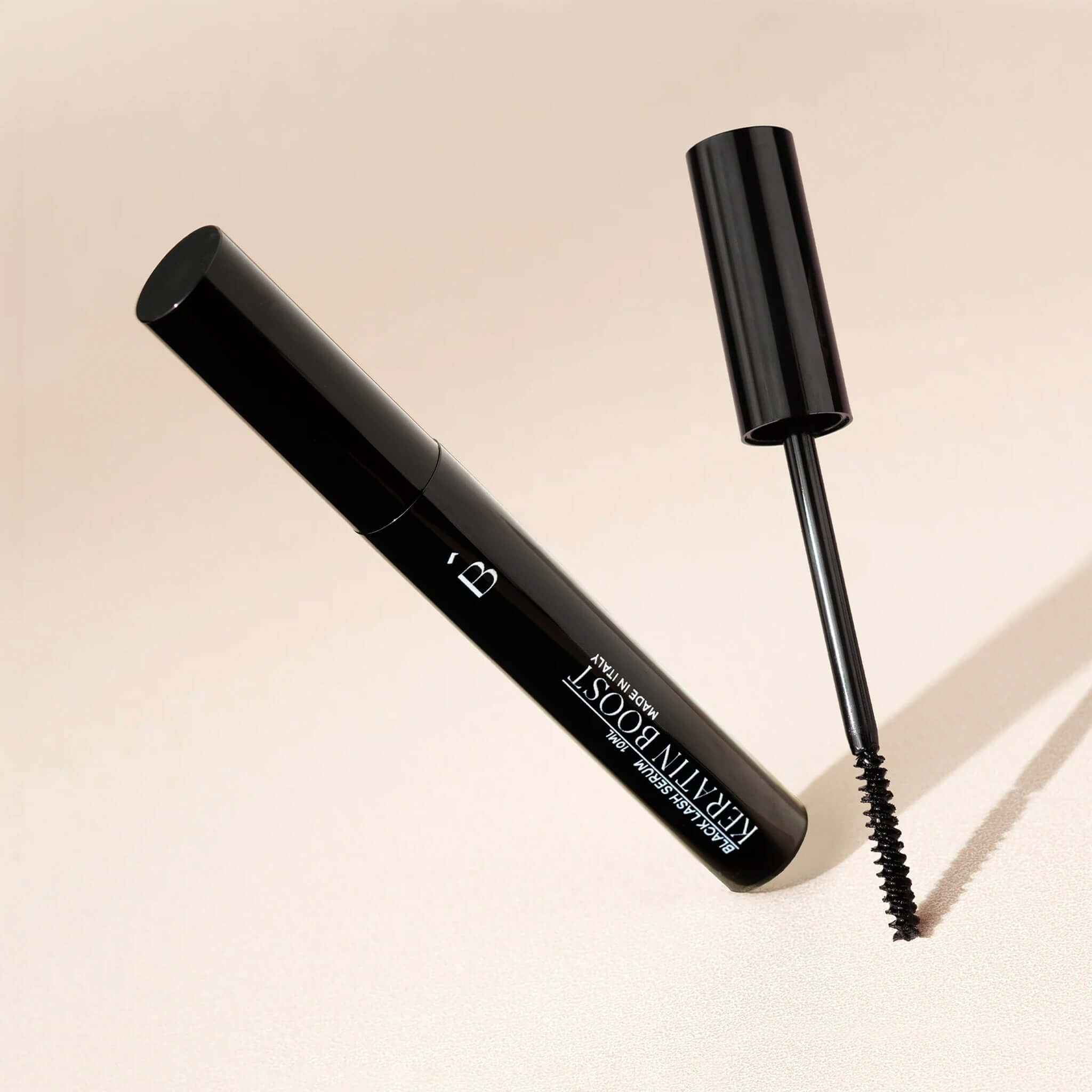 Alt Tag: Bored Brows Black Lash Serum tube and wand applicator with subtle black tint for longer, thicker, healthier lashes