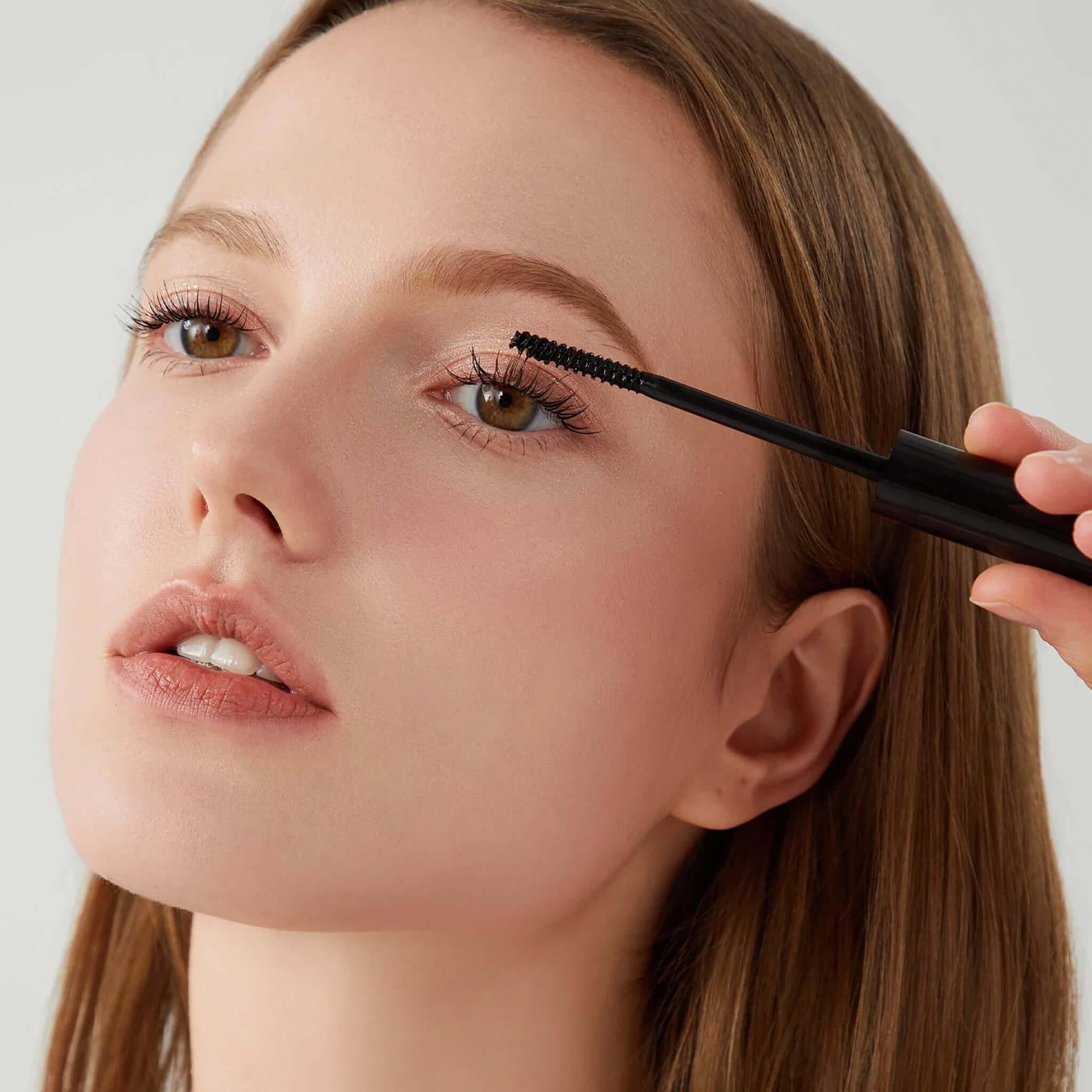 Alt Tag: Bored Brows Black Lash Serum applied to eyelashes for longer, thicker-looking lashes with subtle black tint