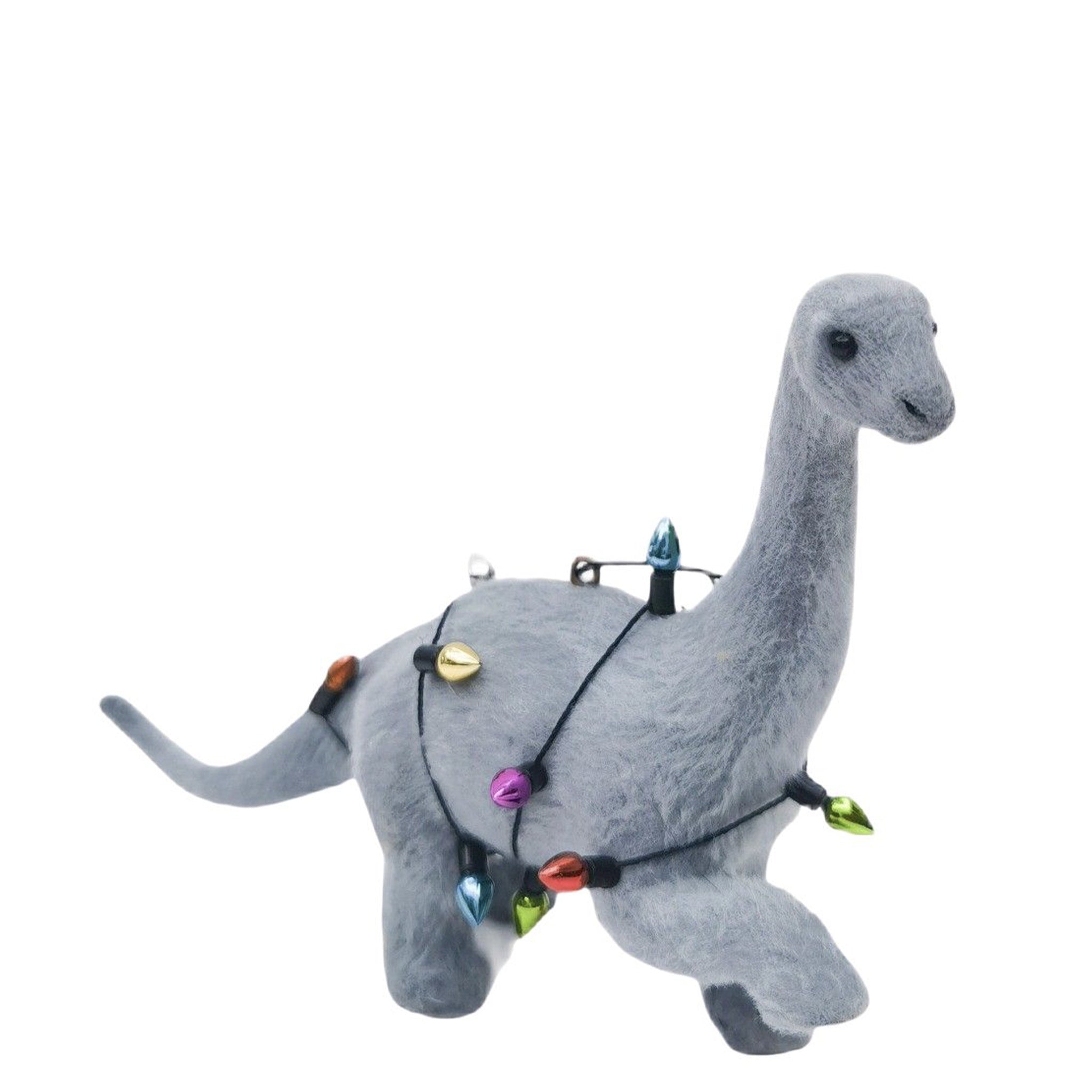 Plush dinosaur decoration with colorful lights on a white background