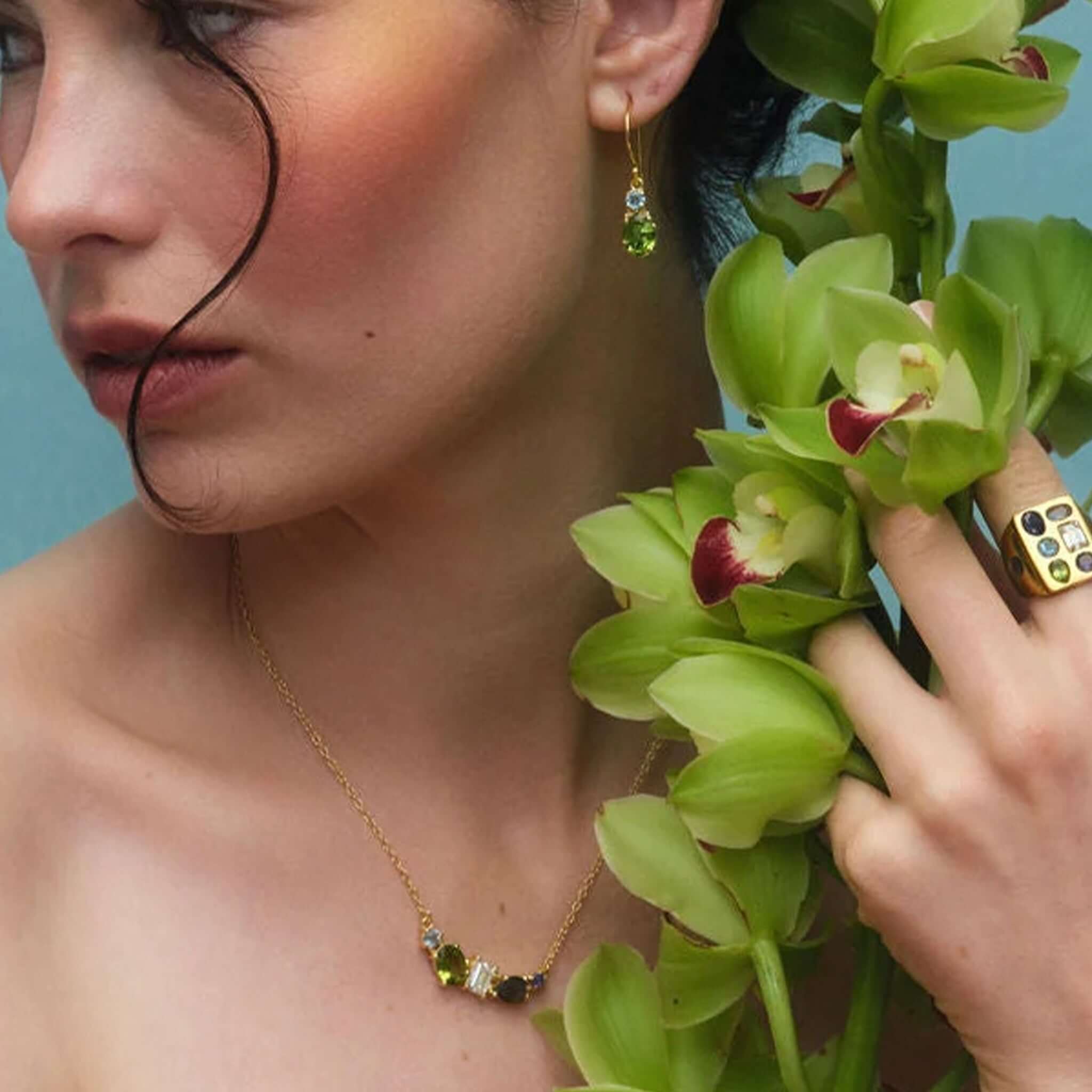 Cathy Pope Elements Collection Gold Necklace - Water worn by model, showcasing vibrant gemstones and elegant design.