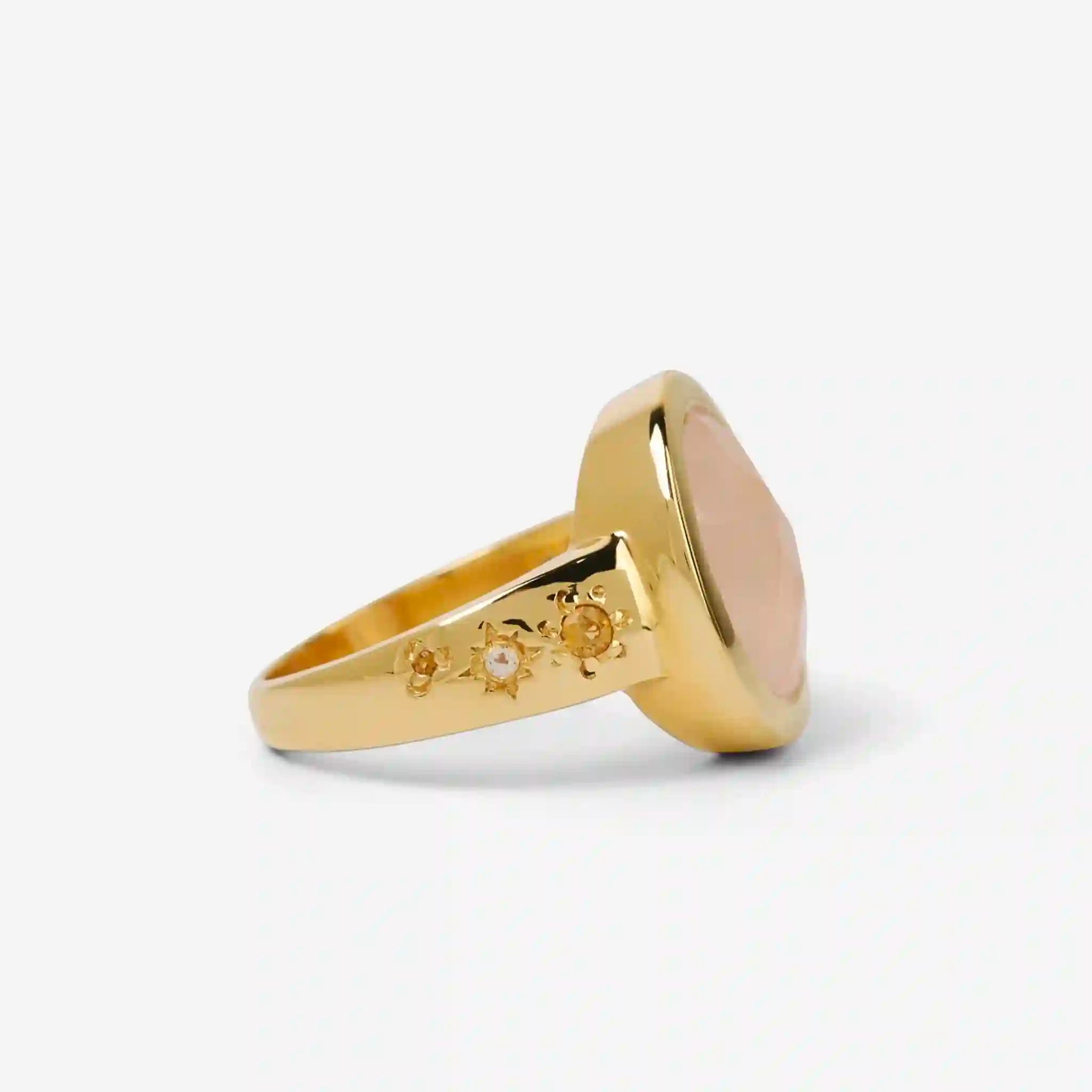 Gold ring with a large pink stone on a white background