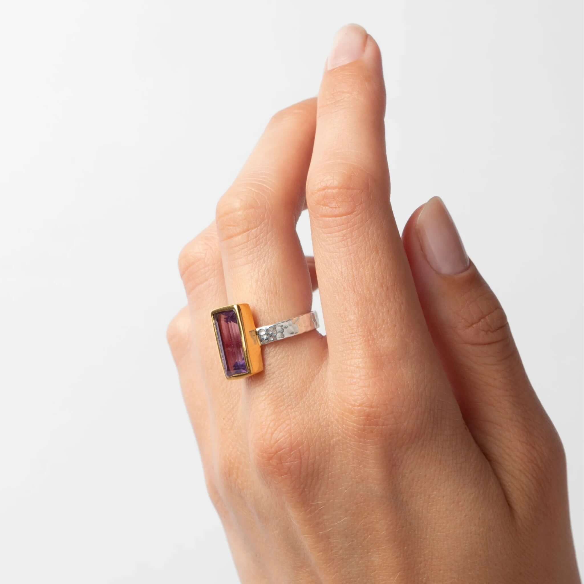 Cathy Pope Oracle Gold & Silver Ring - Amethyst on a hand showcasing the faceted amethyst baguette and textured band.