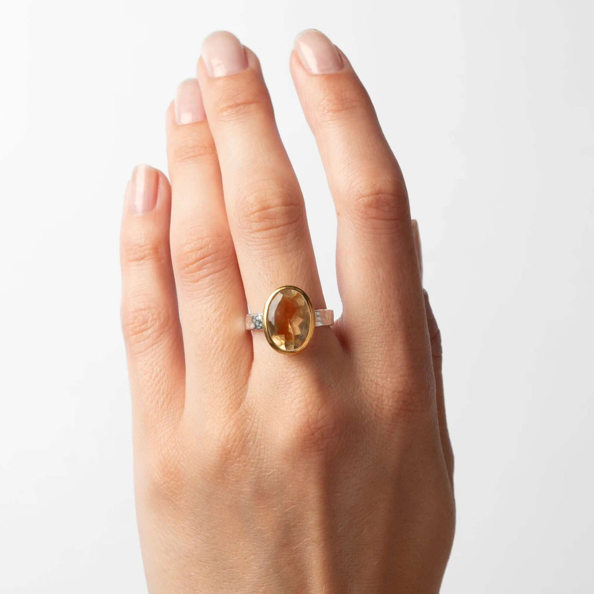 Cathy Pope Oracle Gold & Silver Ring - Citrine featuring a faceted oval citrine stone on a hand.