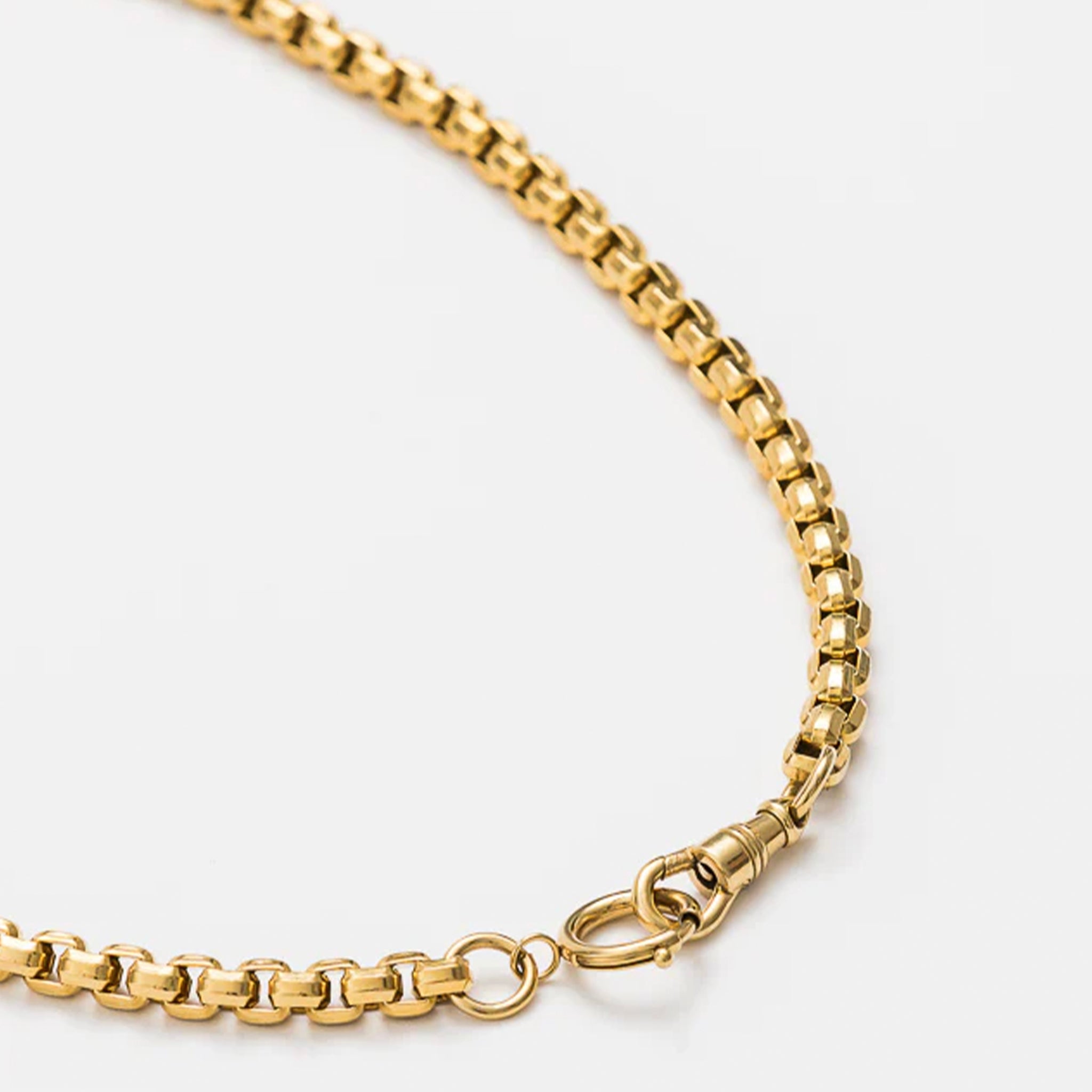 Gold chain necklace on a white background