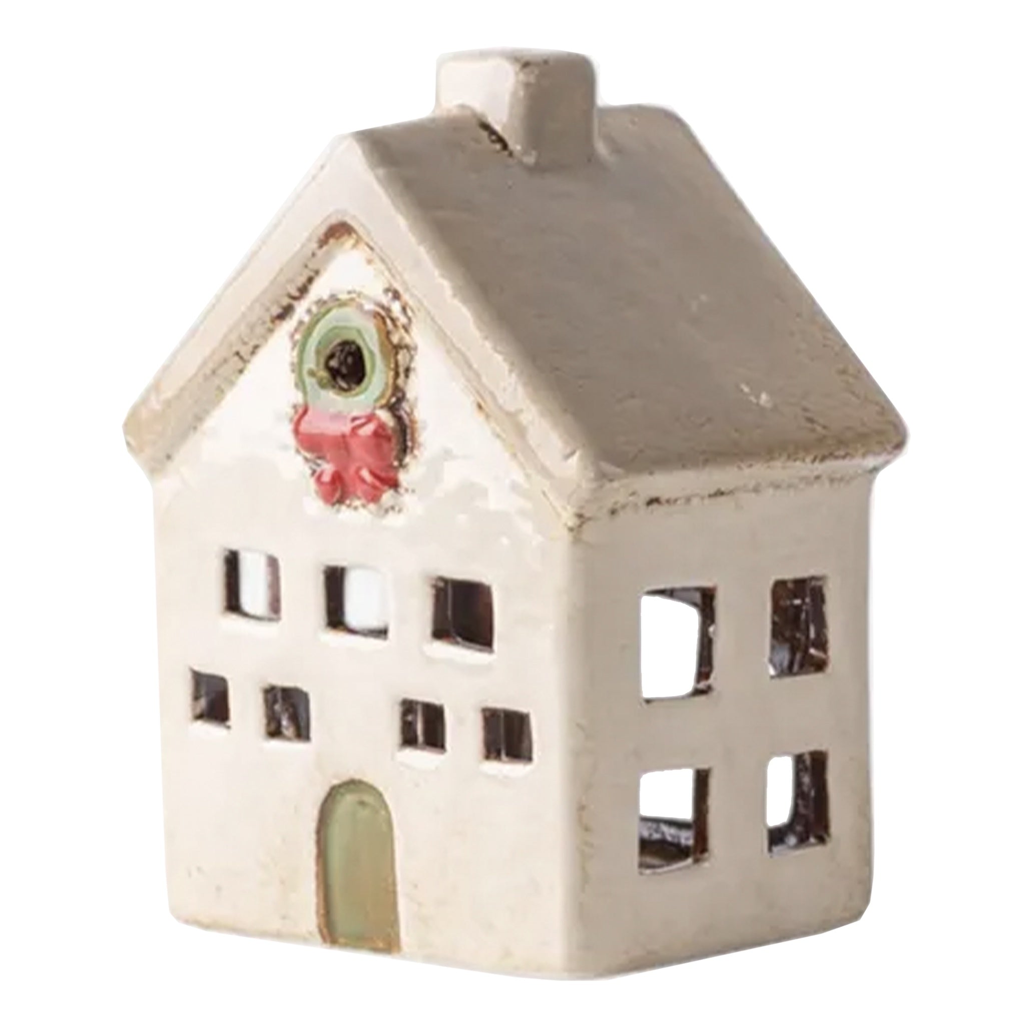 Small ceramic house with a decorative face on a white background