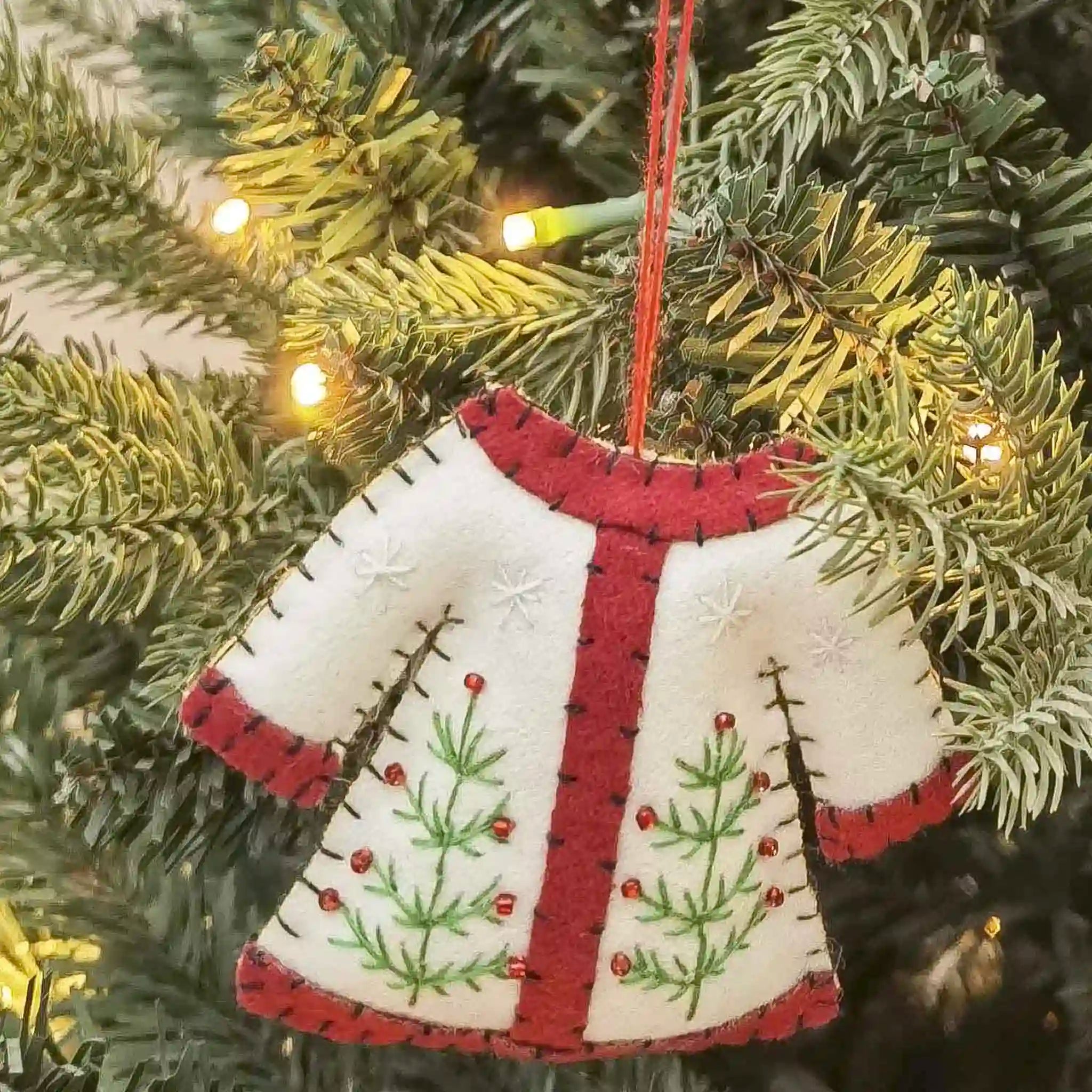 Fabric Christmas coat decoration on a tree.