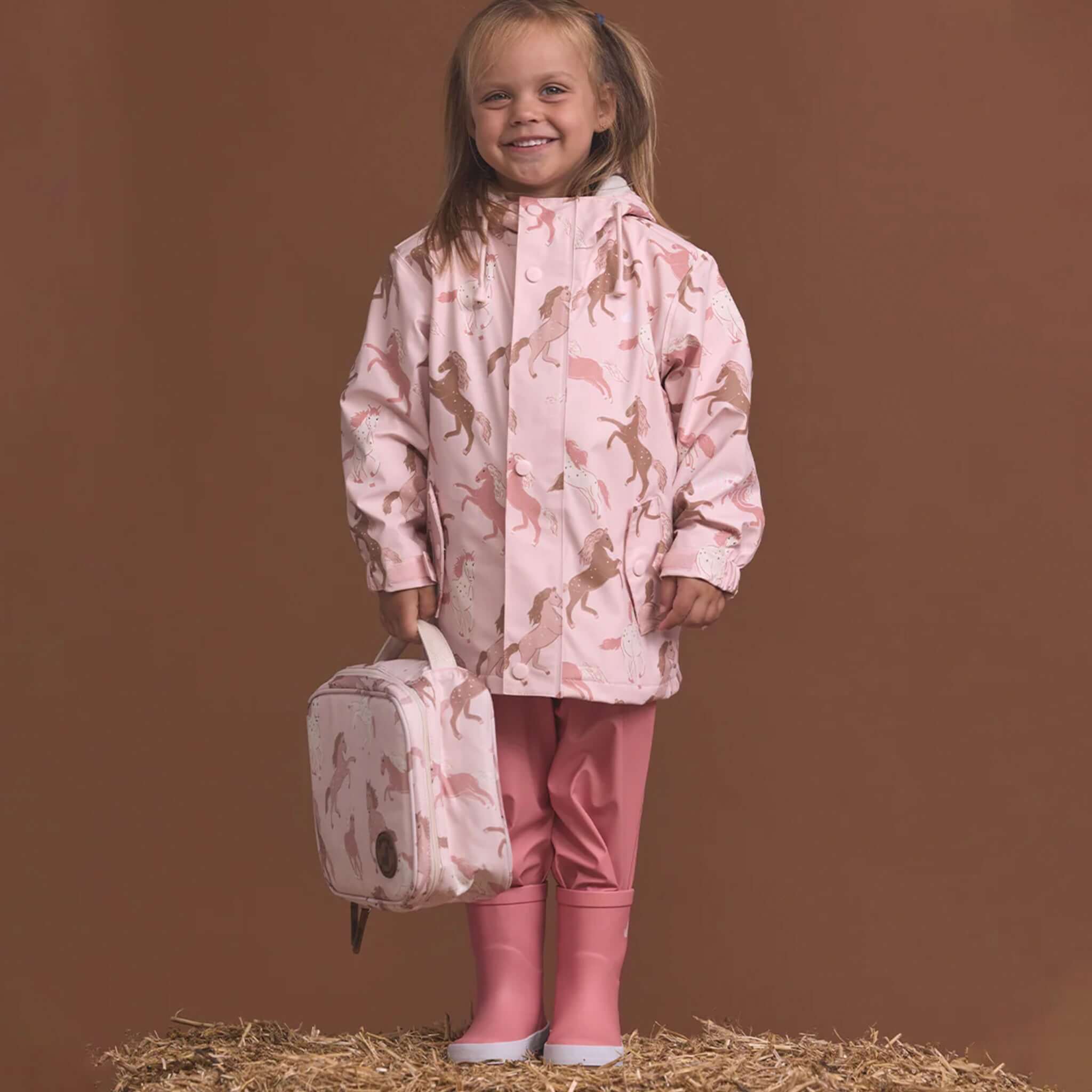 Alt Tag: Crywolf Everyday Lunch Bag - Blush Ponies insulated kids lunch bag in pink pony print, carried by child