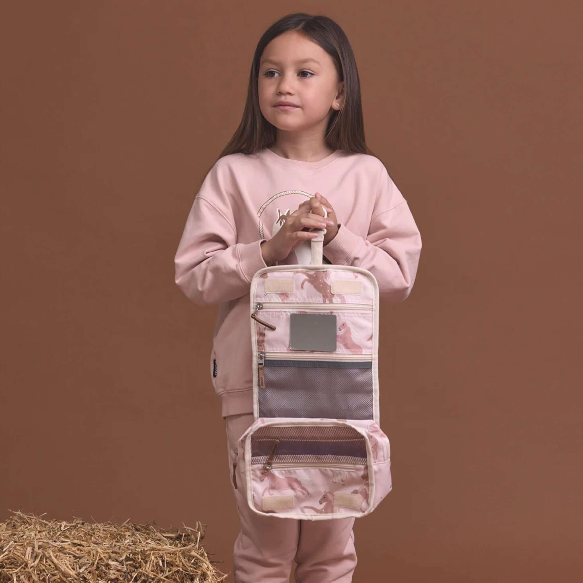 Alt Tag: Crywolf Hanging Toiletry Bag - Blush Ponies hanging kids toiletry organiser with pony print, zip mesh pockets and mirror