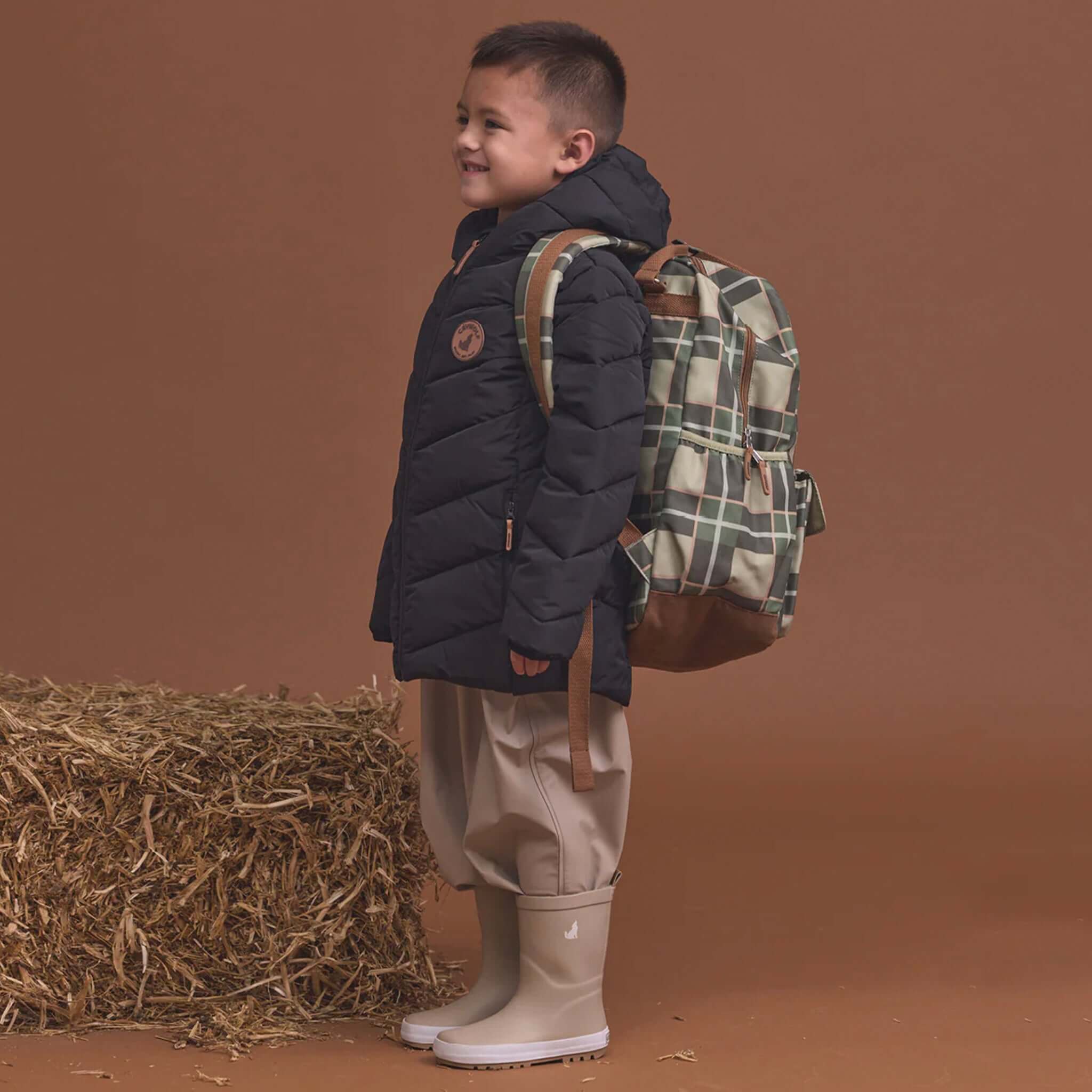 Crywolf Knapsack - Field Plaid kids water-resistant backpack worn by child, spacious eco-friendly recycled school bag for travel and play
