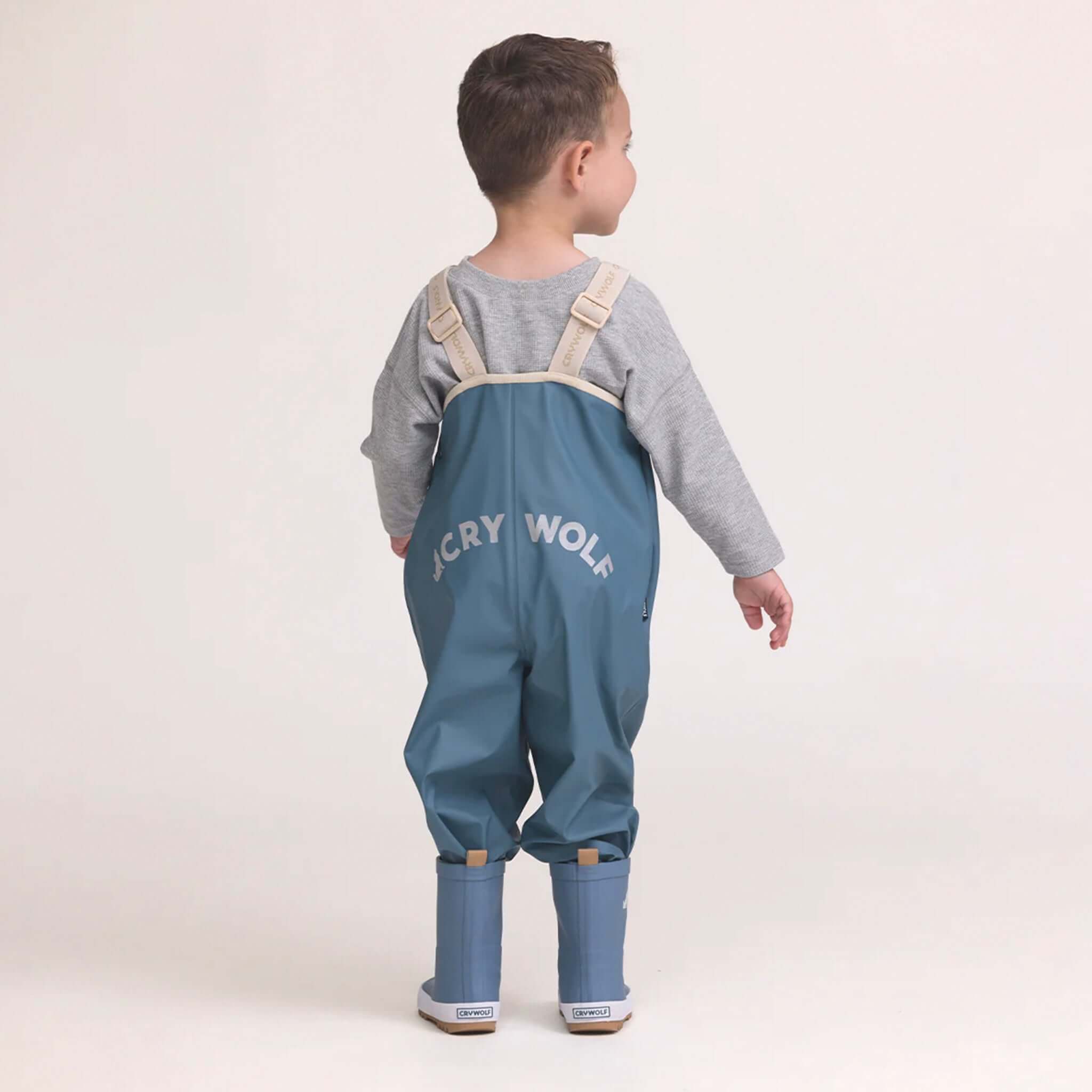 Alt Tag: Crywolf Rain Overalls - Highland Blue waterproof kids rain bib overalls, adjustable straps, back view for outdoor play