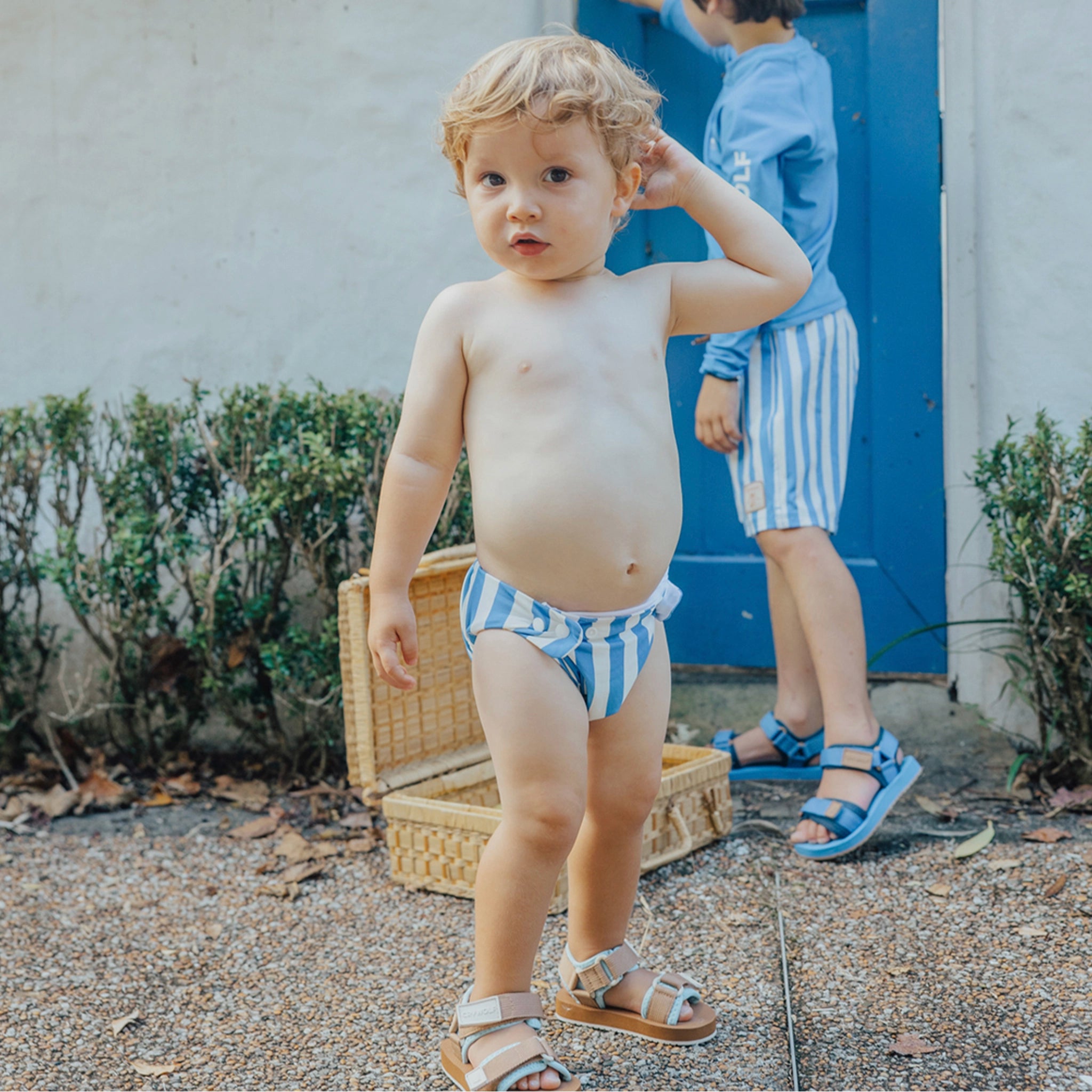 Toddler wearing a blue and white striped swim nappy