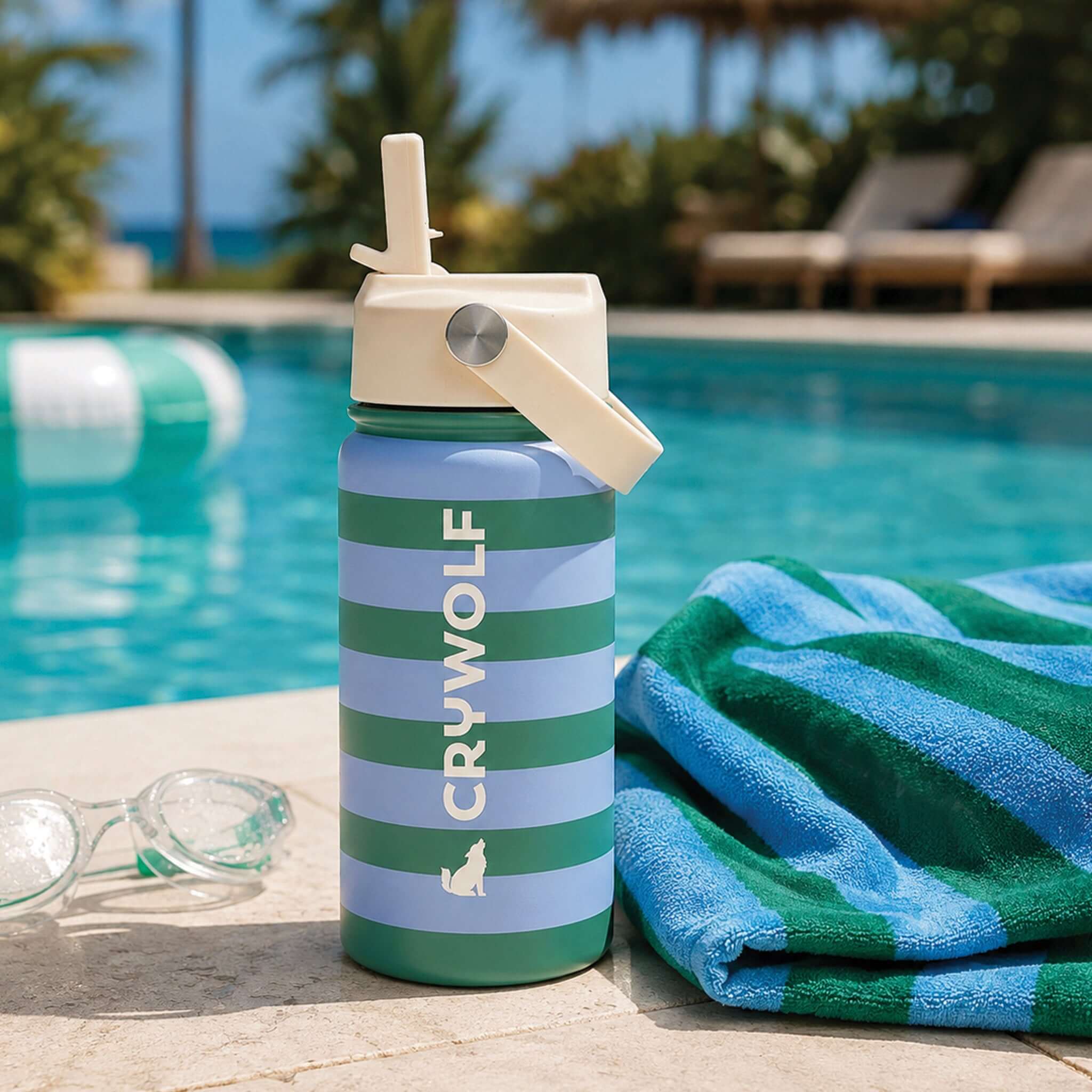 Crywolf Stainless Steel Drink Bottle 360ml - Flamingo Stripe beside a pool with towels and sunglasses.