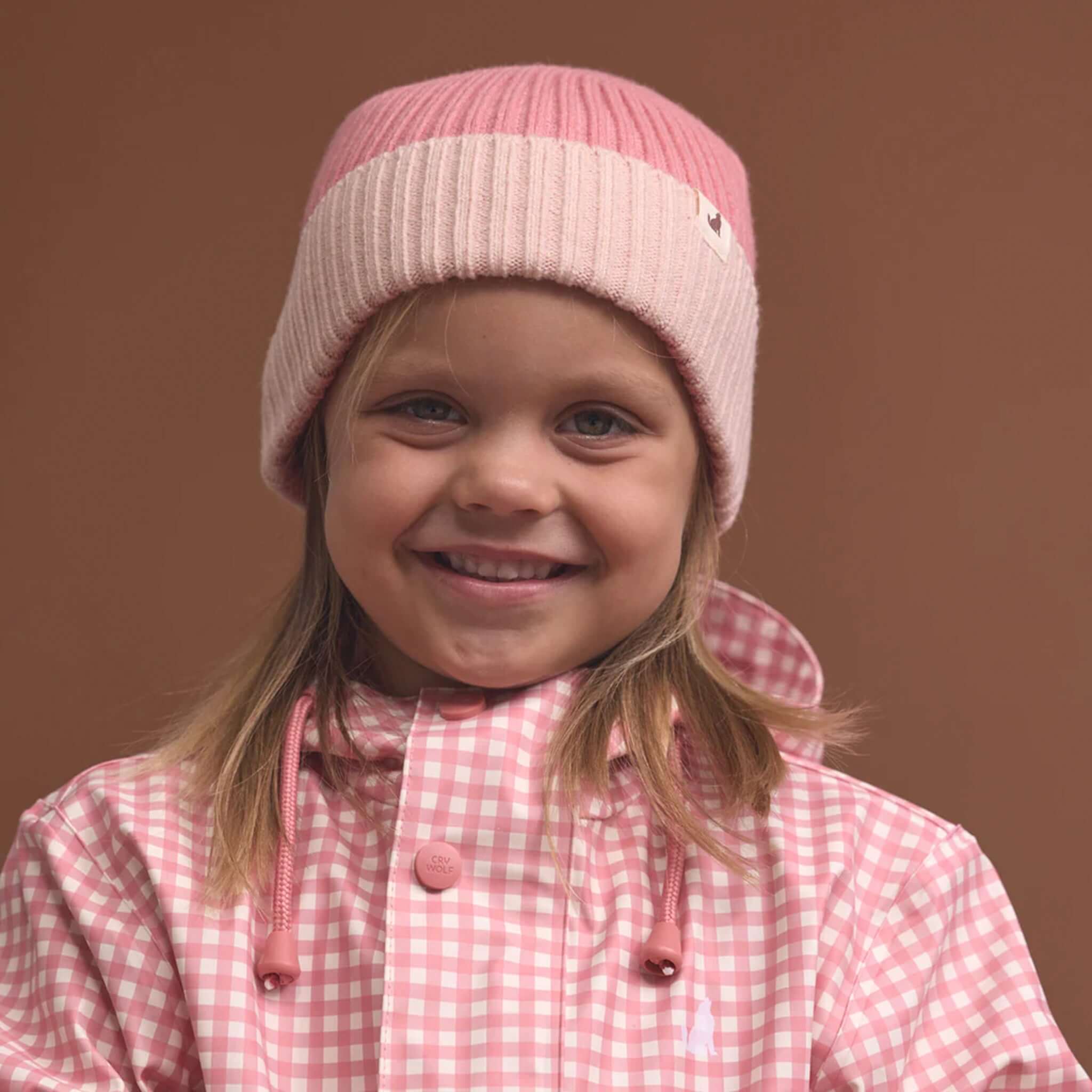 Alt Tag: Crywolf Tasman Beanie - Rose on child, slimline ribbed knit colourblock beanie for kids, soft warm Polylana® fibre