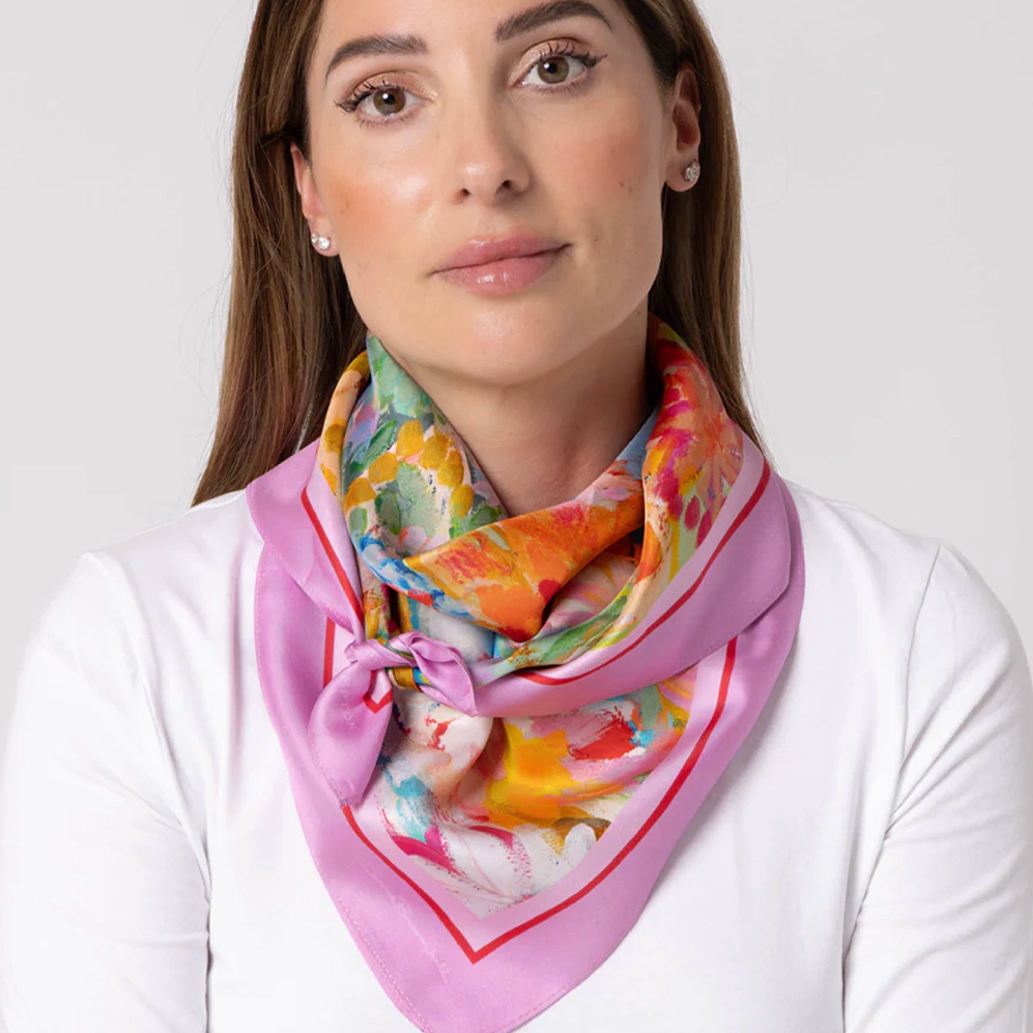 Woman wearing a colorful scarf with a white background