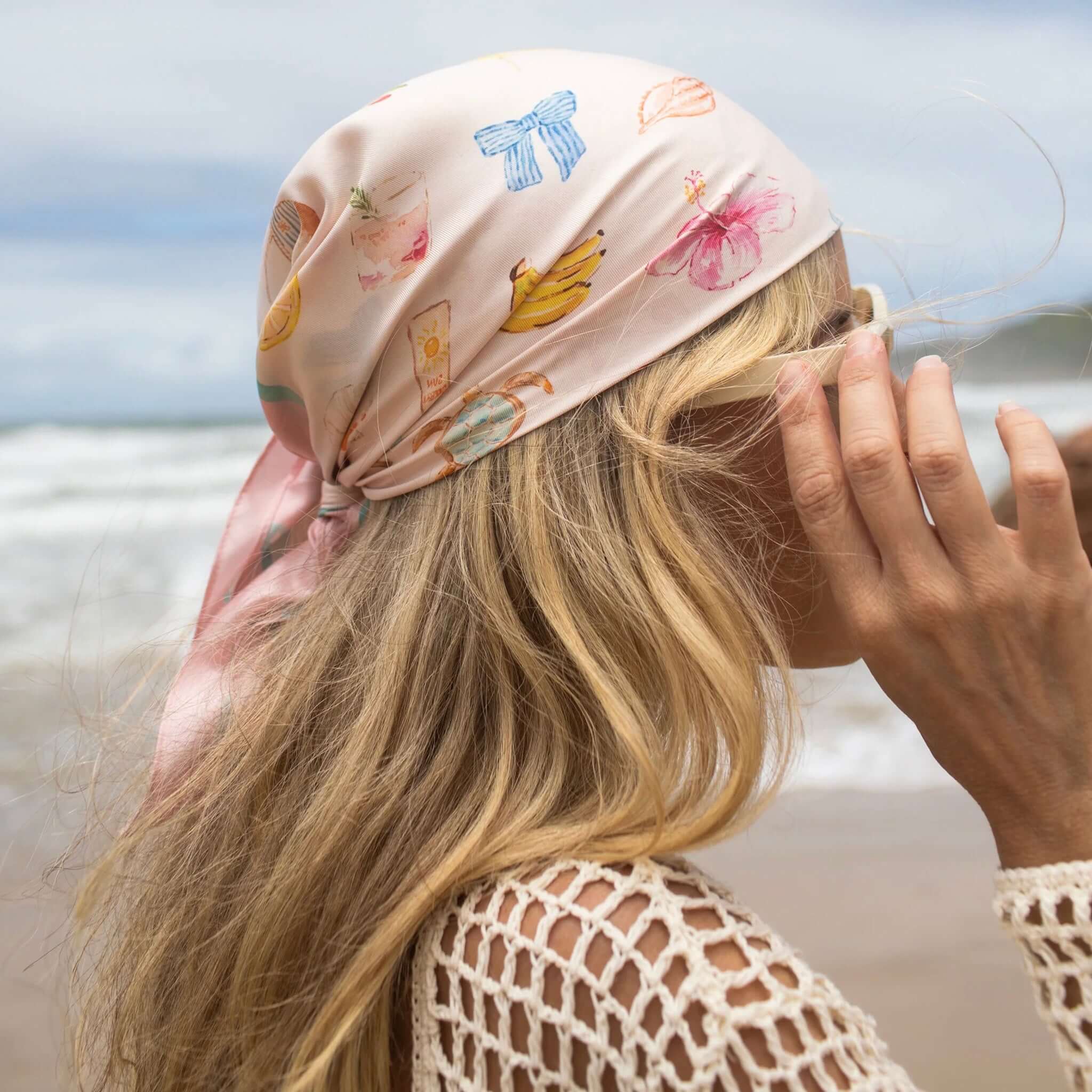 Woman wearing a patterned headscarf at the beach