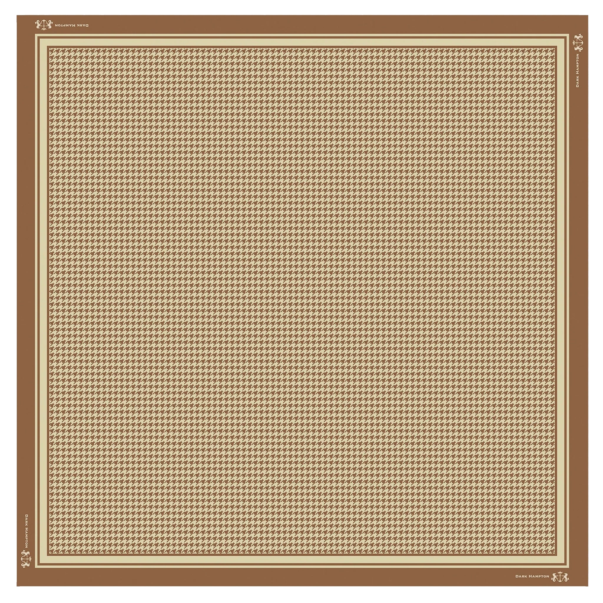 Beige and brown houndstooth patterned rug with brand logo in the corner