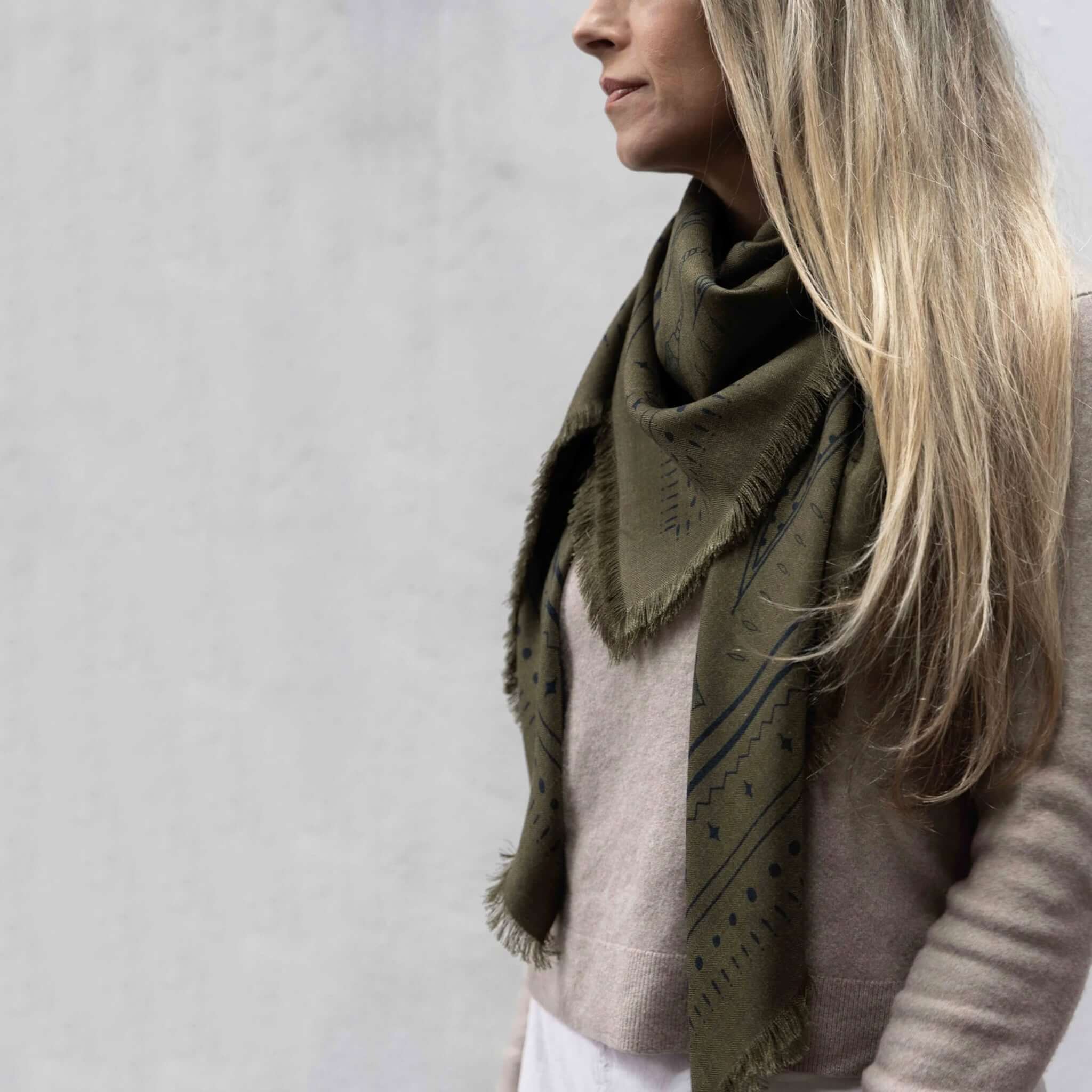 Dark Hampton x Ellie Compton the Yorke Wool Silk Scarf worn by a model, highlighting its olive and black colorway.