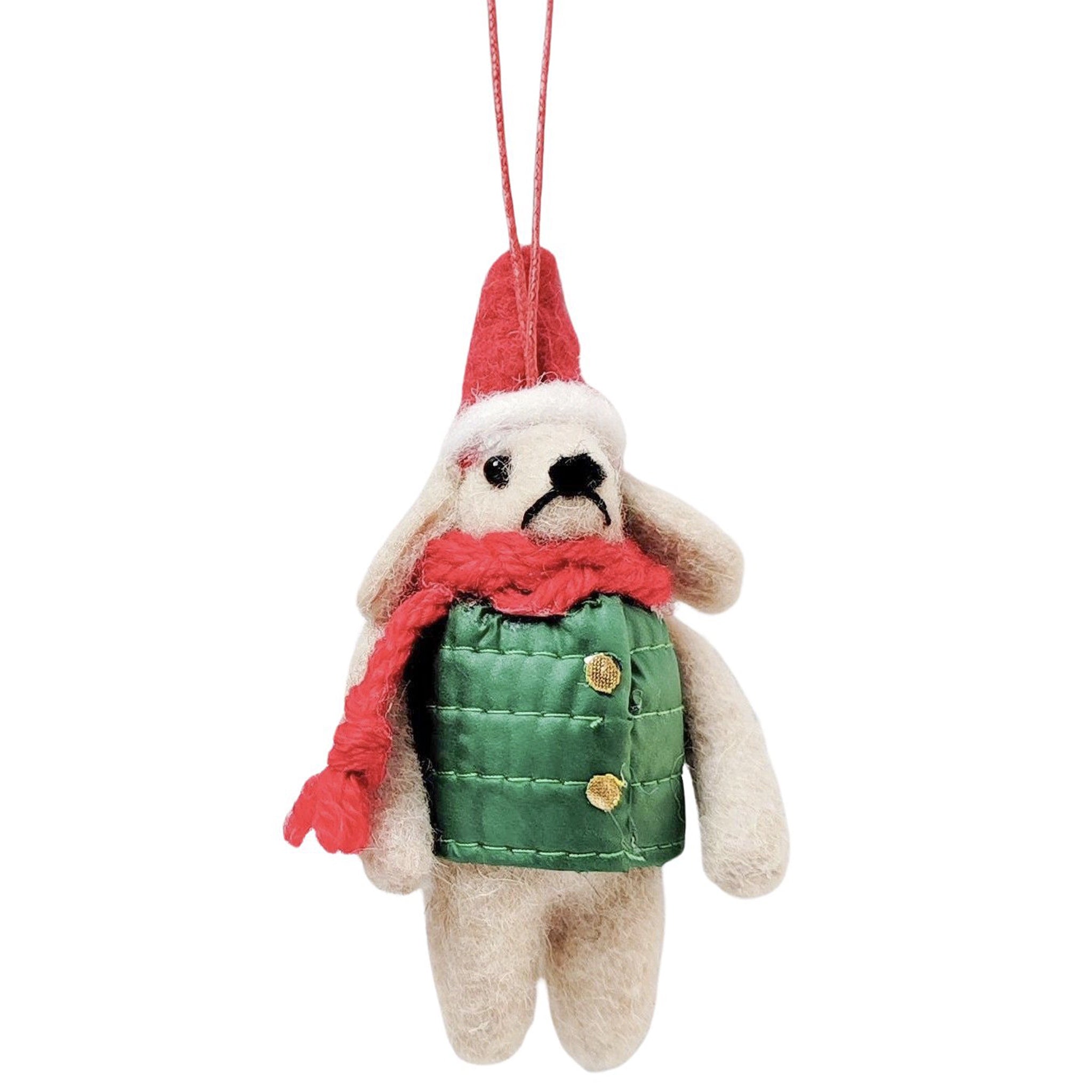 Small plush dog ornament wearing a red hat, green vest, and pink scarf on a white background