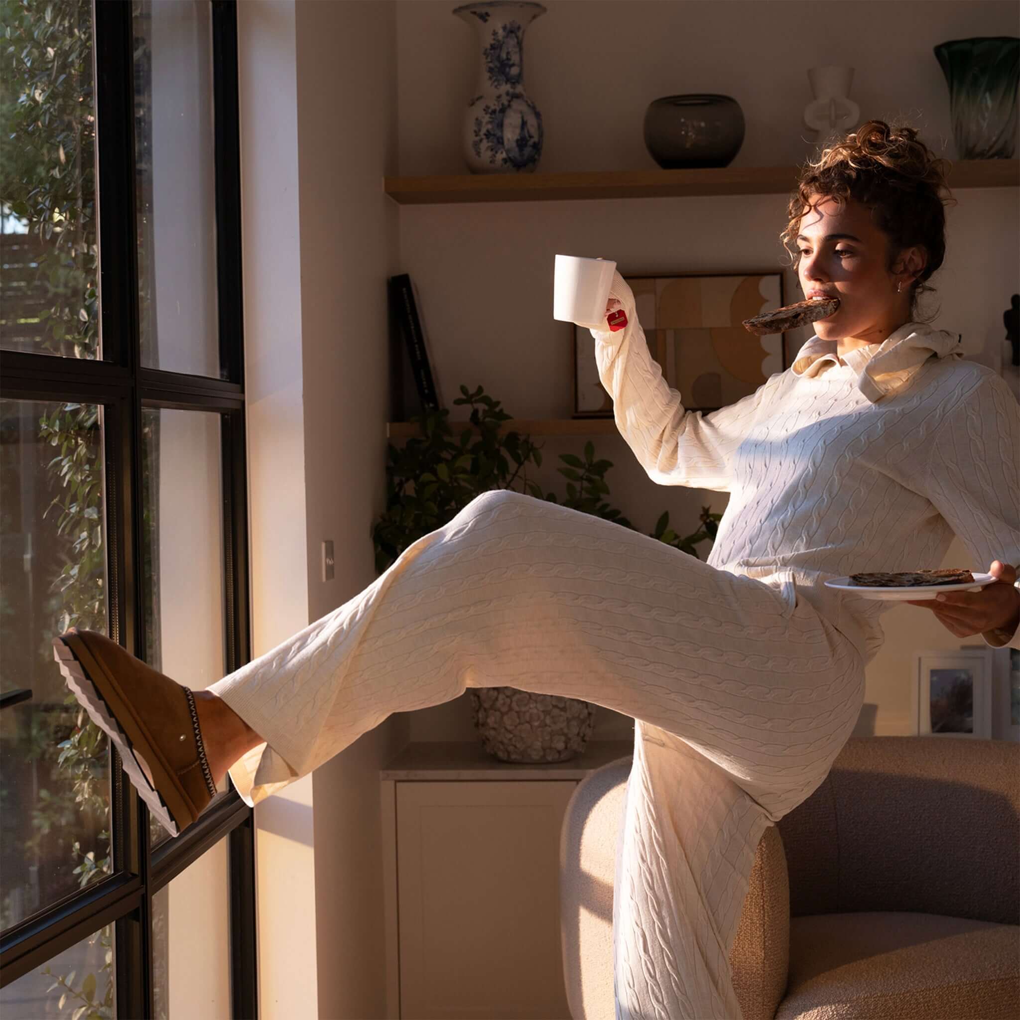 Alt Tag: EMU Sharky Scuff Slippers - Chestnut worn indoors, cosy sheepskin slip-on slippers with Sharky sole grip, lounging at home