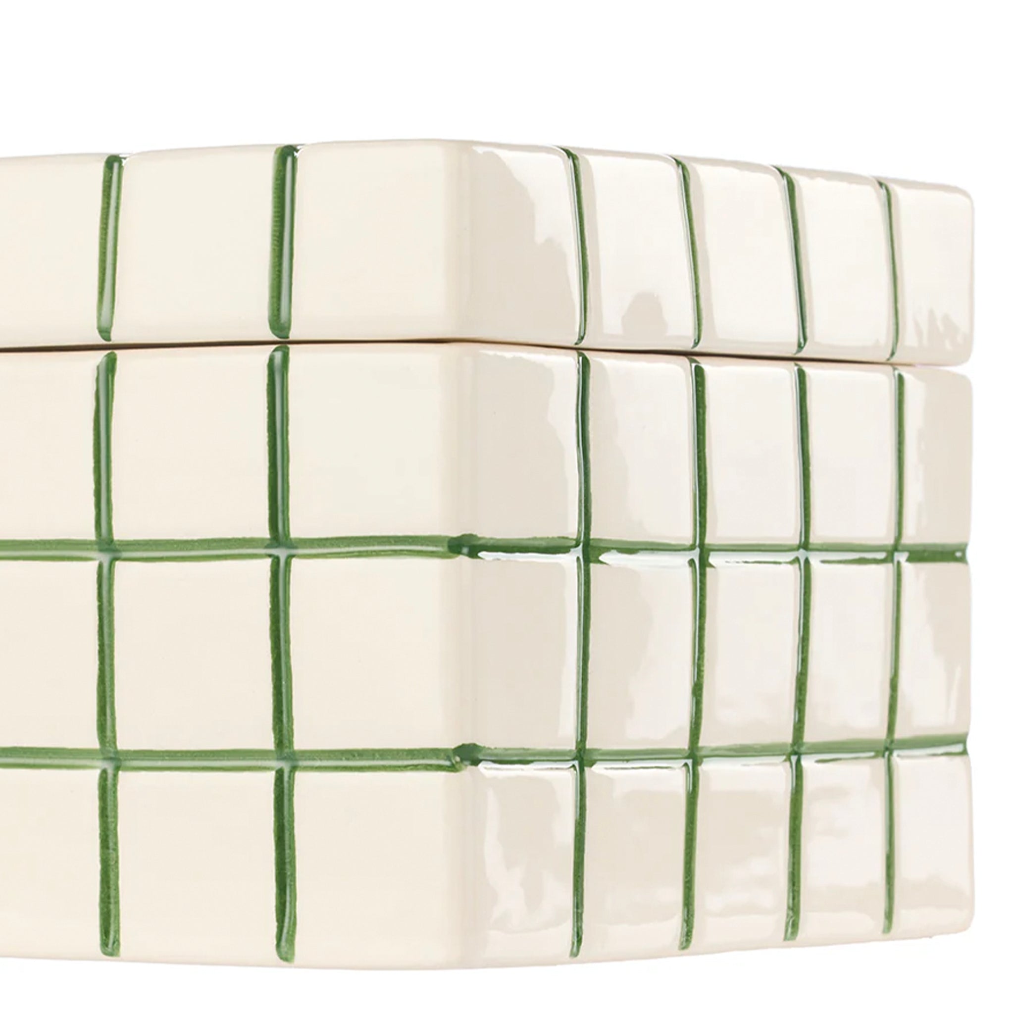 White quilt with green checkered pattern on a white background