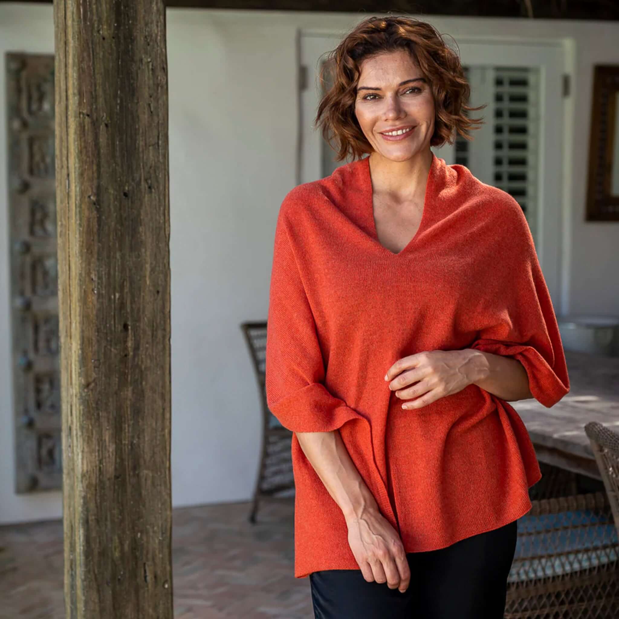 Esperance & Co Classic Cashmere Topper - Autumn worn casually, showcasing its vibrant orange color and versatile style.
