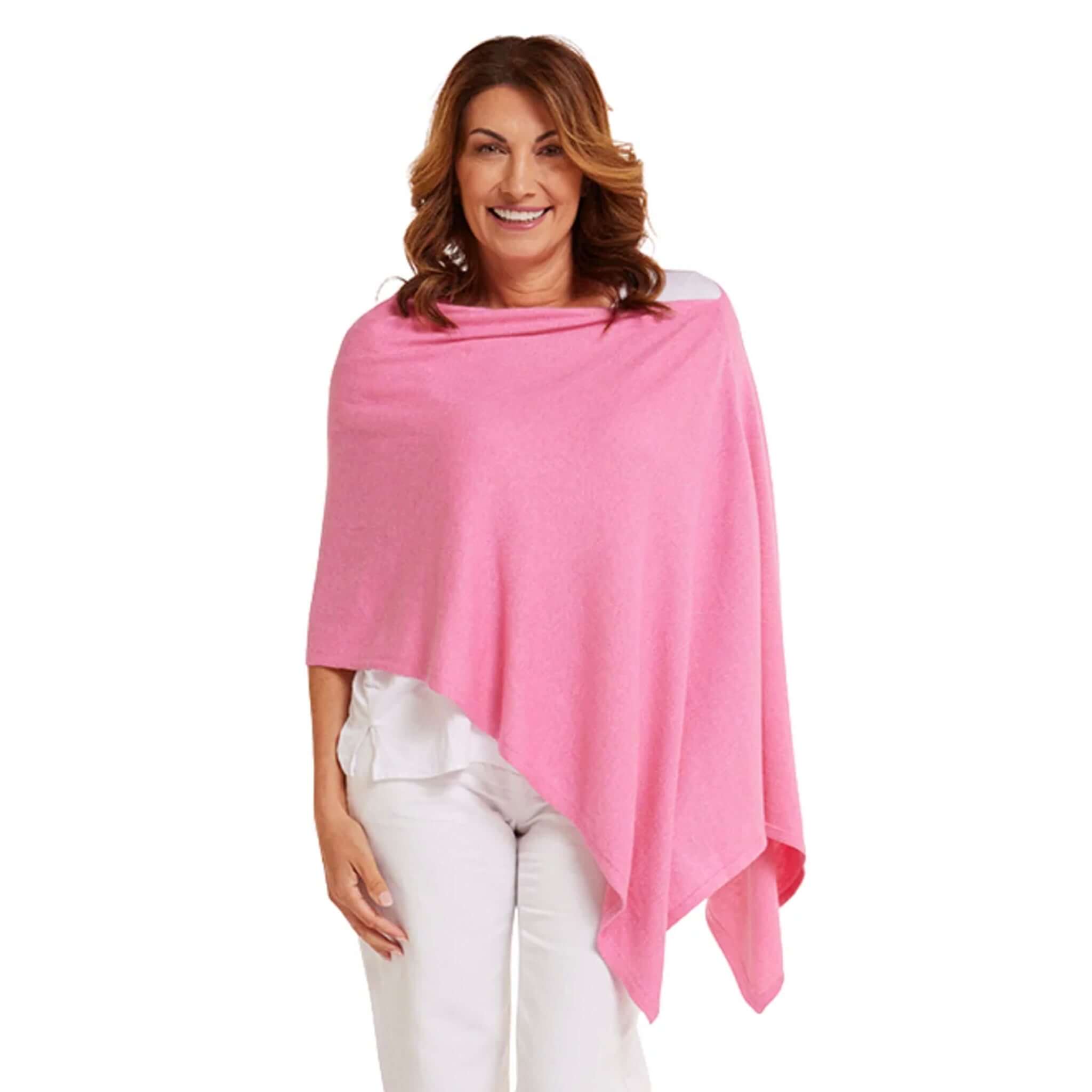 Esperance & Co Classic Cashmere Topper - Glam Pink worn as a stylish poncho, adding elegance and color to any outfit.