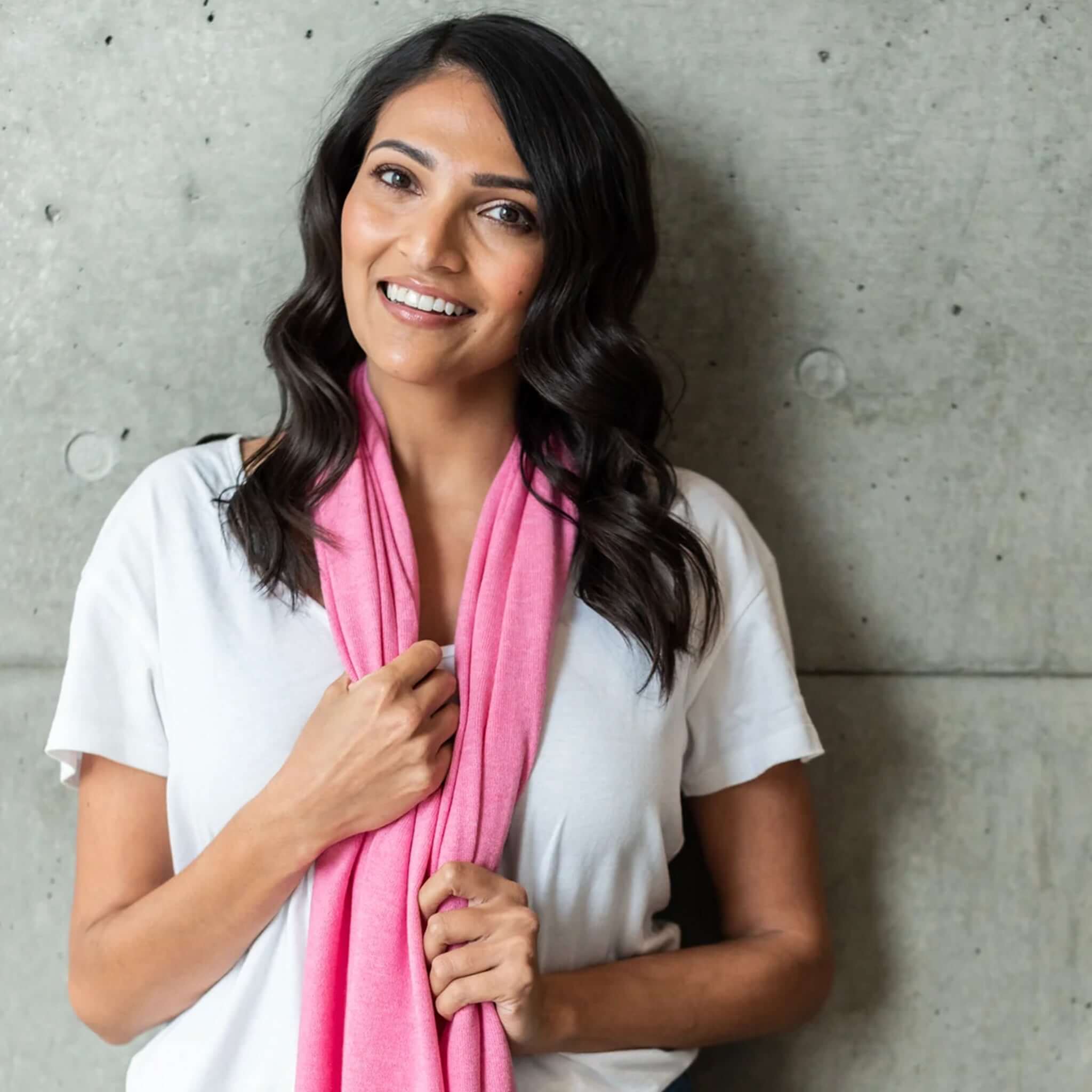 Esperance & Co Classic Cashmere Topper - Glam Pink worn by a woman, adding a pop of color to her outfit.