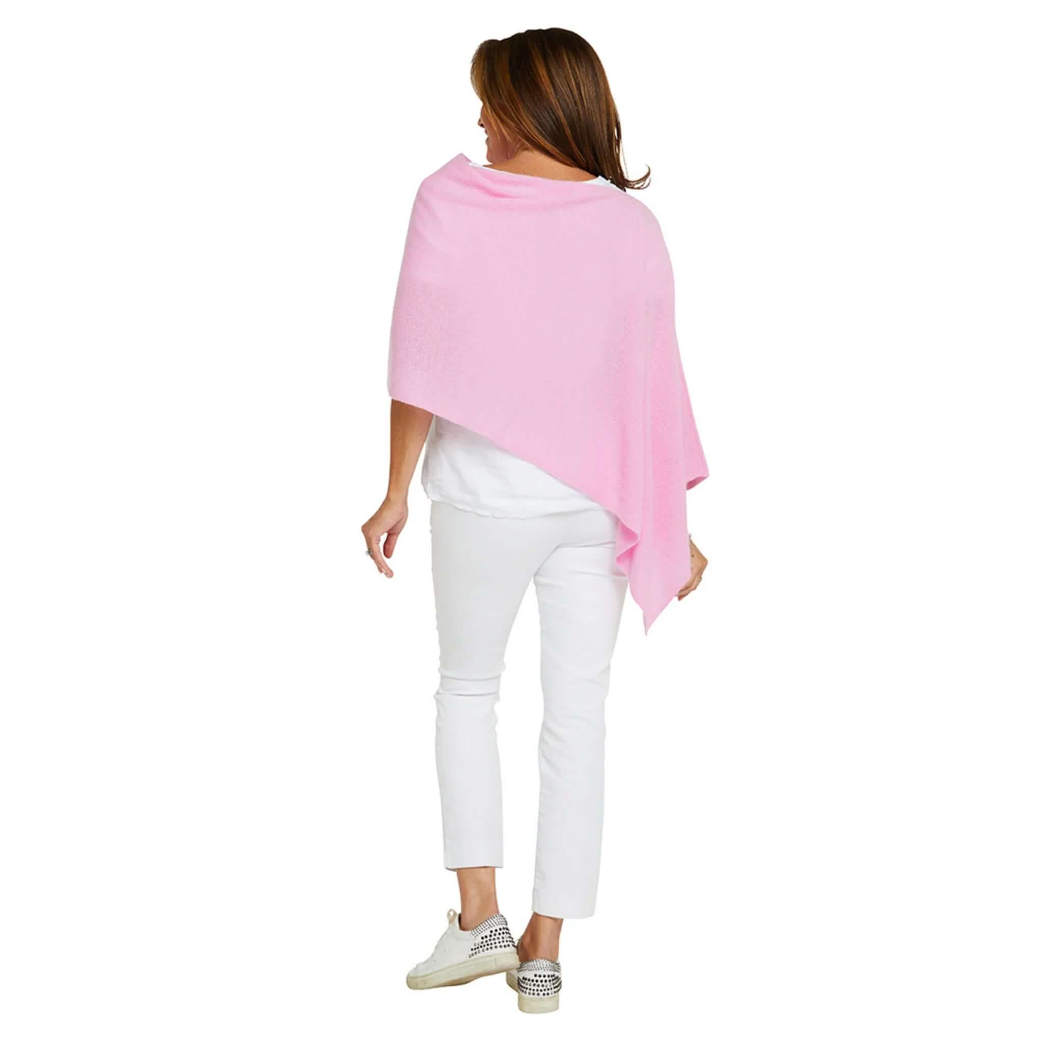 Woman wearing Esperance & Co Classic Cashmere Topper - Glam Pink, styled casually with white pants and sneakers.