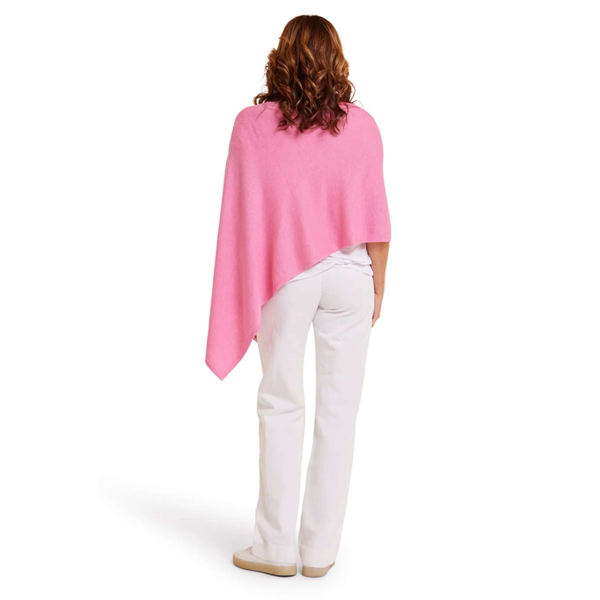Woman wearing the Esperance & Co Classic Cashmere Topper - Glam Pink from the back, showcasing its elegant design.